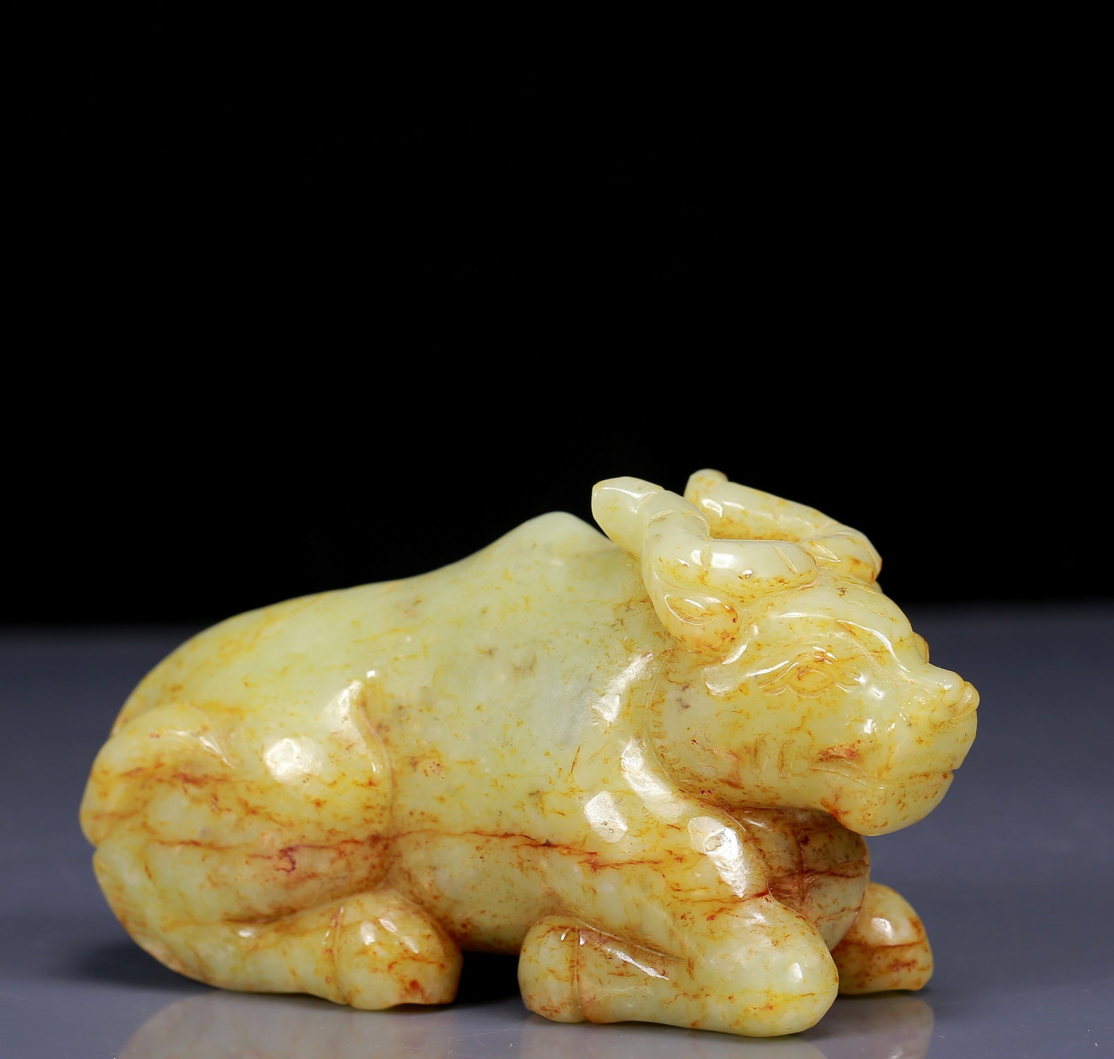 An Exquisite Yellow Jade Buffalo Ornament: An Exquisite Yellow Jade Buffalo Ornament,Qing Dynasty, China,Size:5.7inx2.4inx3.1in,Weight:1040g 黄玉牛摆件，清代