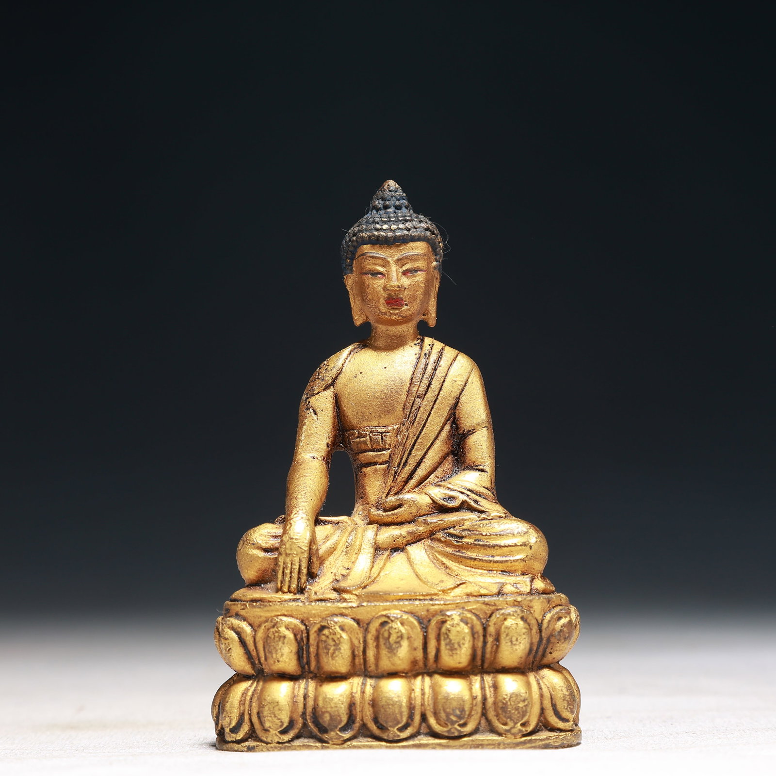 A Solemn Gilt Bronze Statue of Sakyamuni: A Solemn Gilt Bronze Statue of Sakyamuni,Qing Dynasty,China,Size:2.2inx1.6inx3.5in,Weight:250g 铜鎏金释迦摩尼像,中国清代