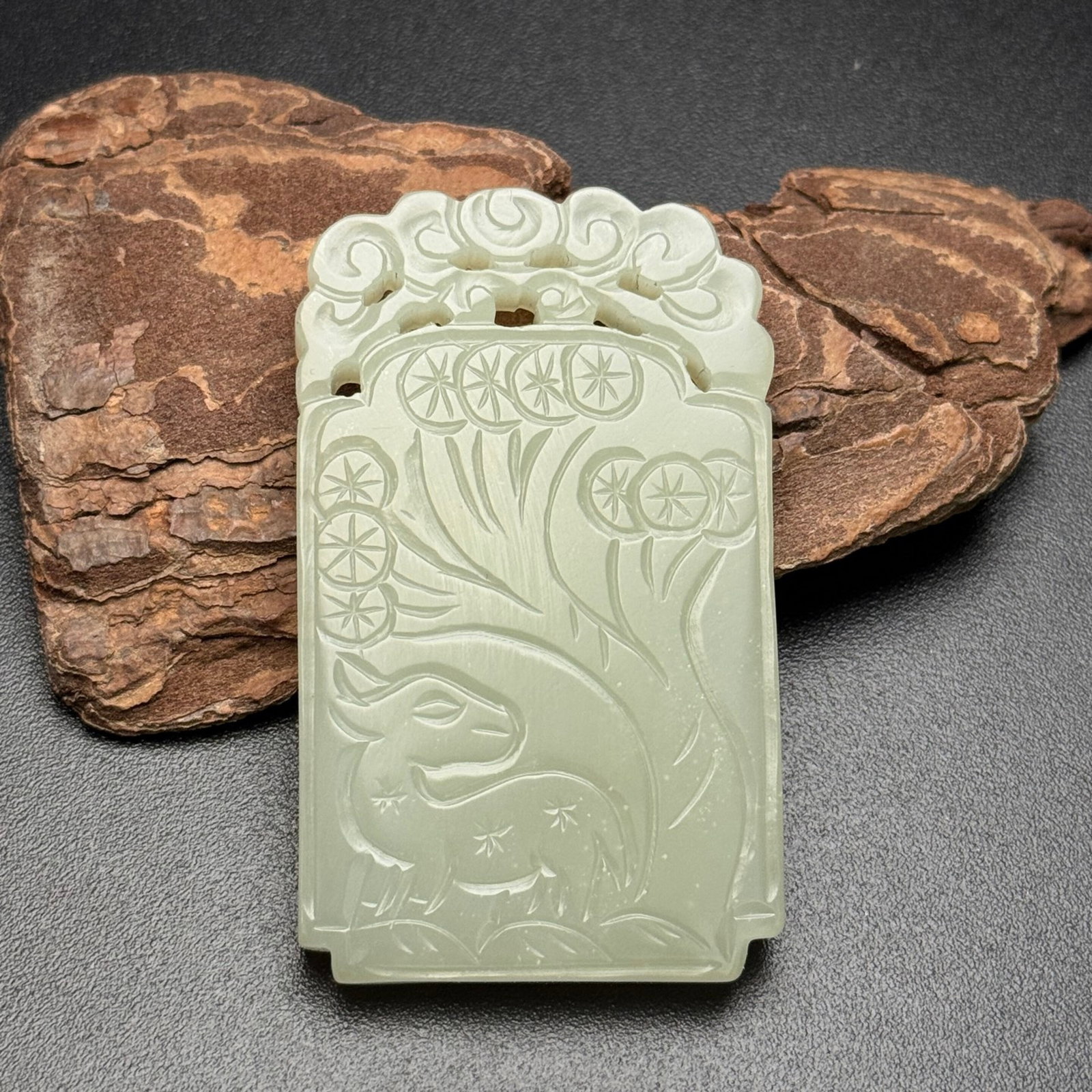 An Exquisite White Jade Pine and Deer Pattern Pendant: An Exquisite White Jade Pine and Deer Pattern Pendant,Qing Dynasty,China,Size:61mmx36mmx6.5mm,Weight:37g 白玉松鹿纹挂件,中国清代