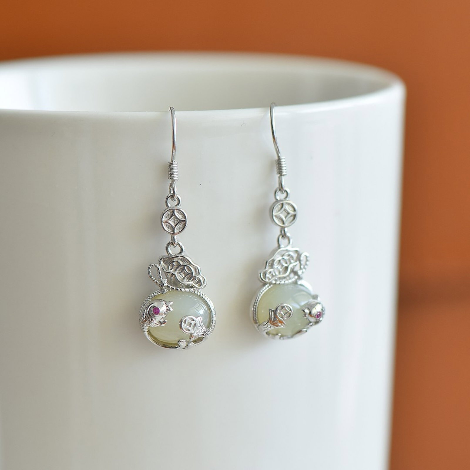 A Pair of Exquisite Sterling Silver Inlaid White Jade Earrings: A Pair of Exquisite Sterling Silver Inlaid White Jade Earrings,Size:8mmx10mm 一对纯银镶白玉耳环