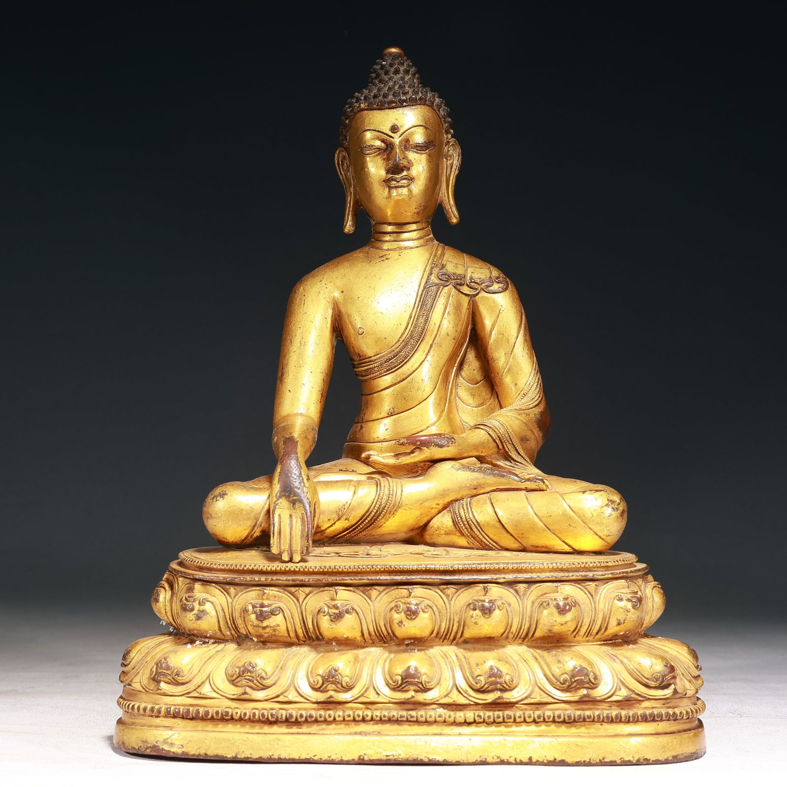 A Solemn Gilt Bronze Statue of Sakyamuni,With Inscription: A Solemn Gilt Bronze Statue of Sakyamuni,With Inscription,Qing Dynasty, China,Size:9.1inx5.1inx12.2in,Weight:4650g 铜鎏金释迦摩尼像,带铭