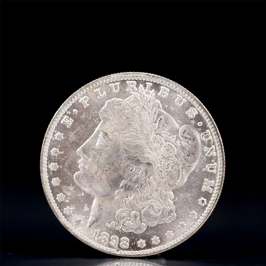 USA Morgan Dollar 1898 Coin: Obv: profile bust with date below and E PLURIBUS UNUM legend and stars around. Rev: eagle with In God we trust above within wreath with UNITED STATES OF AMERICA ONE DOLLAR legend. IN GOD WE TRUST / LI