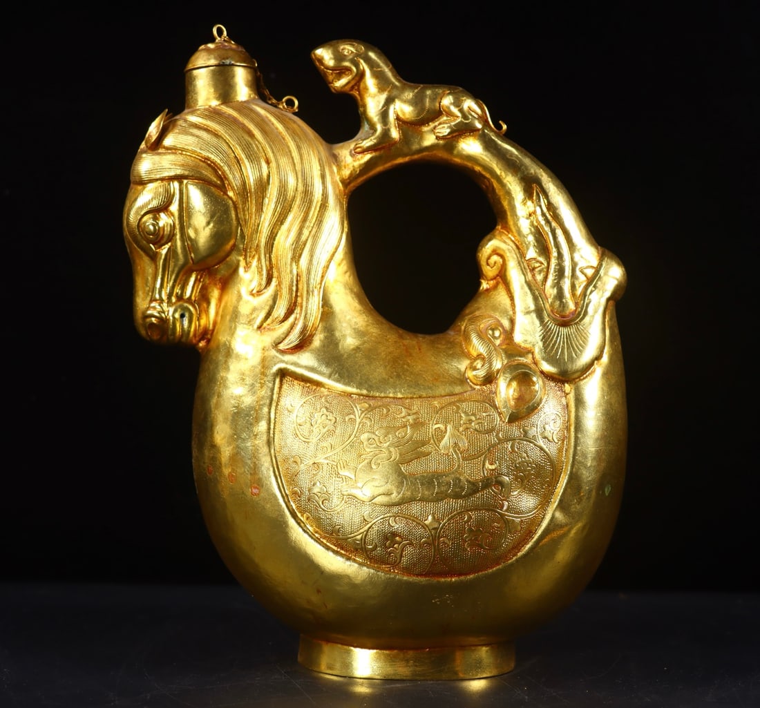 An Exquisite Gilt Bronze Auspicious Beast Pattern Ewer: An Exquisite Gilt Bronze Auspicious Beast Pattern Ewer Tang Dynasty, China Size: 10.2inx7.5inx3.9in Weight:1074g铜鎏金瑞兽纹执壶 中国唐