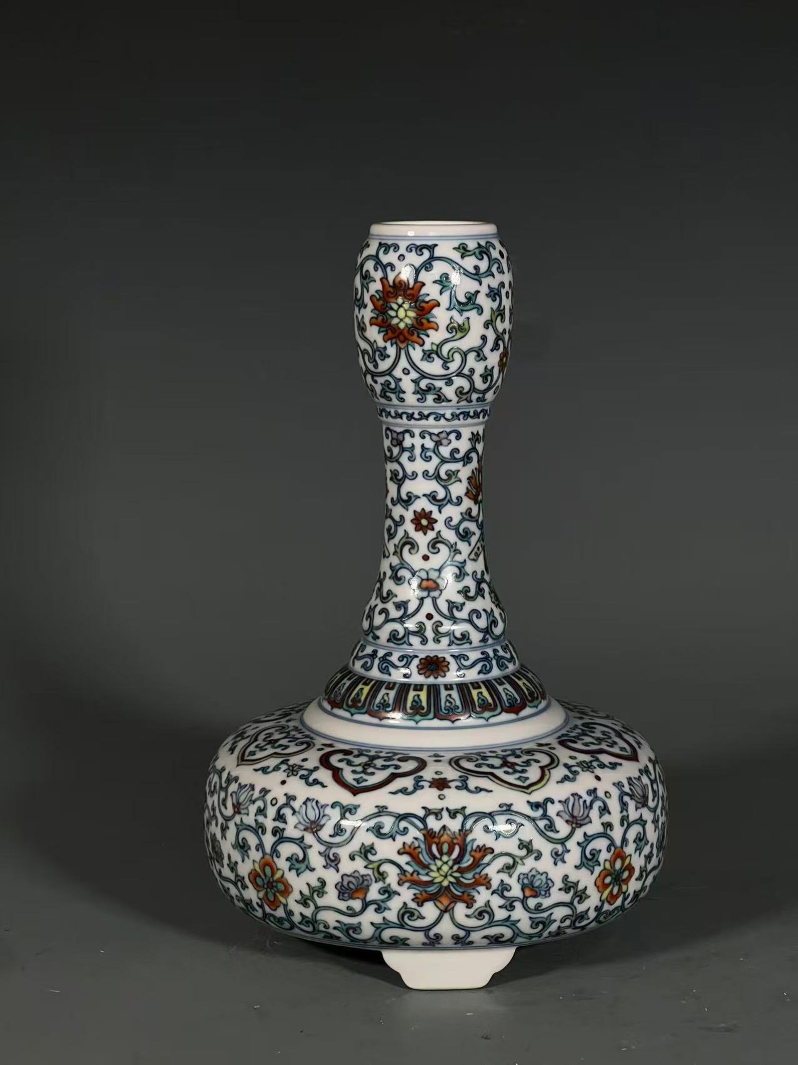 An Exquisite Doucai Lotus Pattern Tripod Vase: An Exquisite Doucai Lotus Pattern Tripod Vase,Qing Dynasty,China,Yongzheng Six-character Mark,Size:9.4inx5.5in
