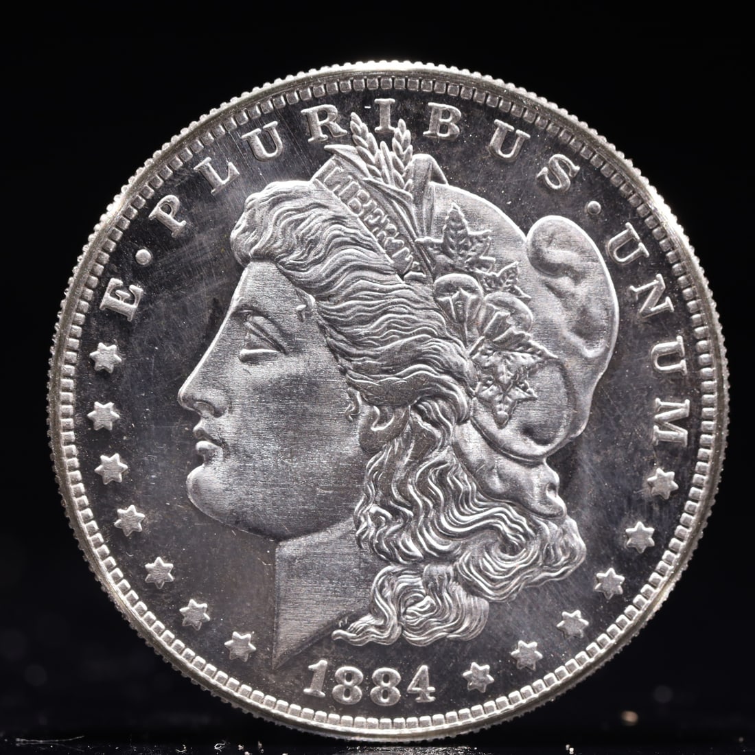 USA Morgan Dollar 1884 Coin: Obv: profile bust with date below and E PLURIBUS UNUM legend and stars around. Rev: eagle with In God we trust above within wreath with UNITED STATES OF AMERICA ONE DOLLAR legend. IN GOD WE TRUST /