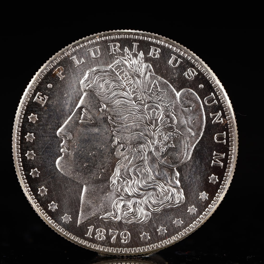 USA Morgan Dollar 1879 Coin: Obv: profile bust with date below and E PLURIBUS UNUM legend and stars around. Rev: eagle with In God we trust above within wreath with UNITED STATES OF AMERICA ONE DOLLAR legend. IN GOD WE TRUST / LI
