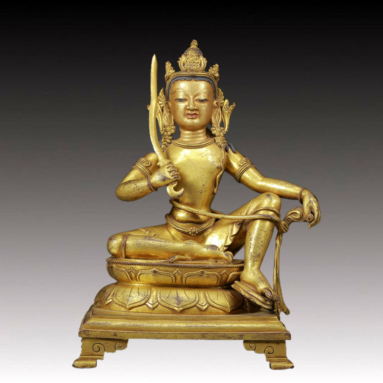 A Magnificent Gilt-Bronze Figure Of Tara: A Magnificent Gilt-Bronze Figure Of Tara. Seated on a base with a peaceful expression, body adorned with jewelry ornaments, topknot surmounted by a splendid diadem, holding a sword. Chinese Ming Dynas