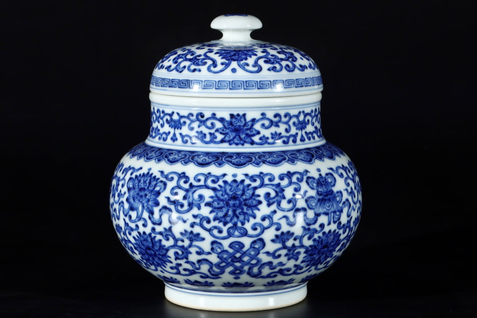 An Exquisite Blue and White Lotus and Eight Treasures Pattern Jar with Cover: An Exquisite Blue and White Lotus and Eight Treasures Pattern Jar with Cover,Qing Dynasty,China,Qianlong Six-character Mark,Size:7.2inx5.6in 青花缠枝莲八宝