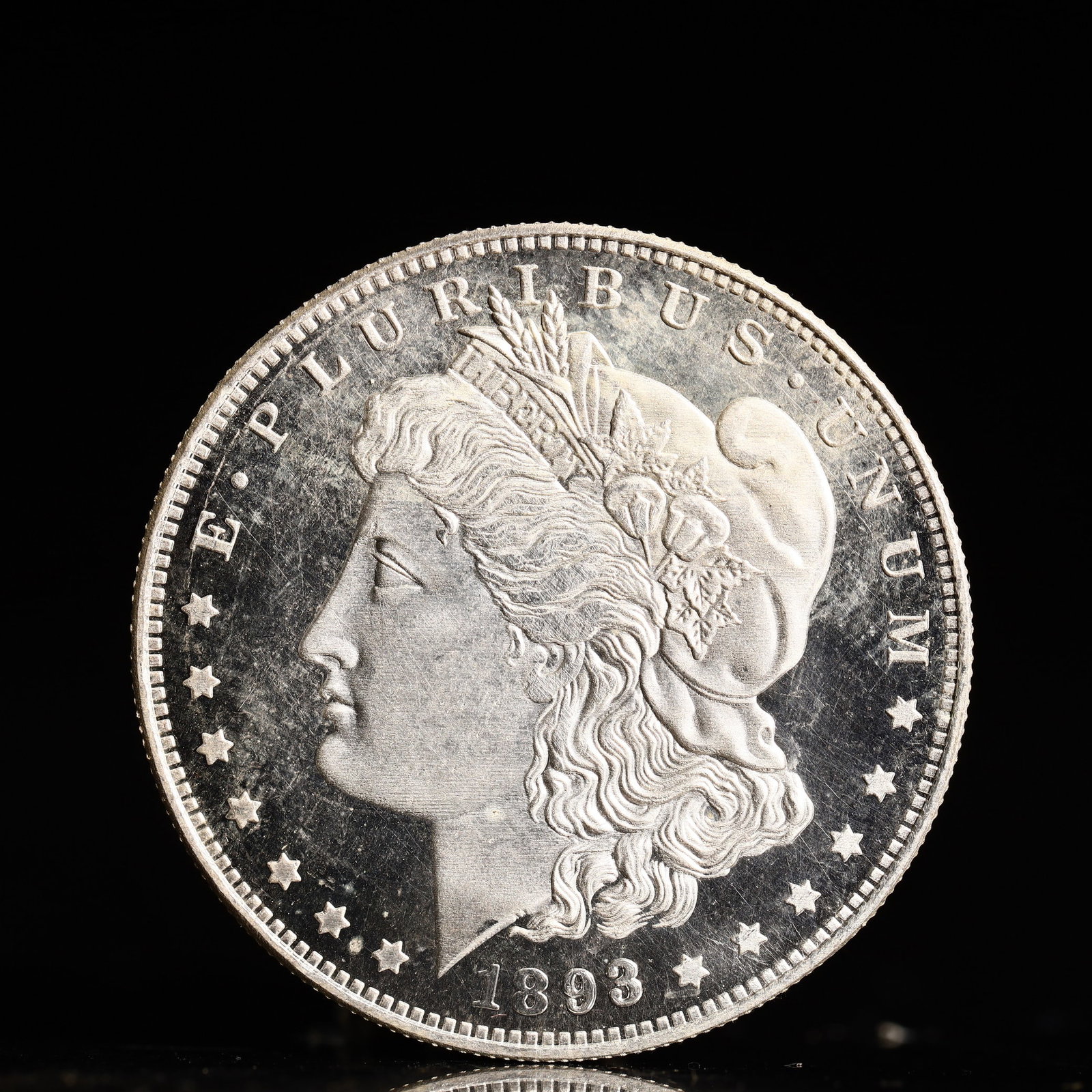 USA Morgan Dollar 1893 Coin: Obv: profile bust with date below and E PLURIBUS UNUM legend and stars around. Rev: eagle with In God we trust above within wreath with UNITED STATES OF AMERICA ONE DOLLAR legend. IN GOD WE TRUST / LI