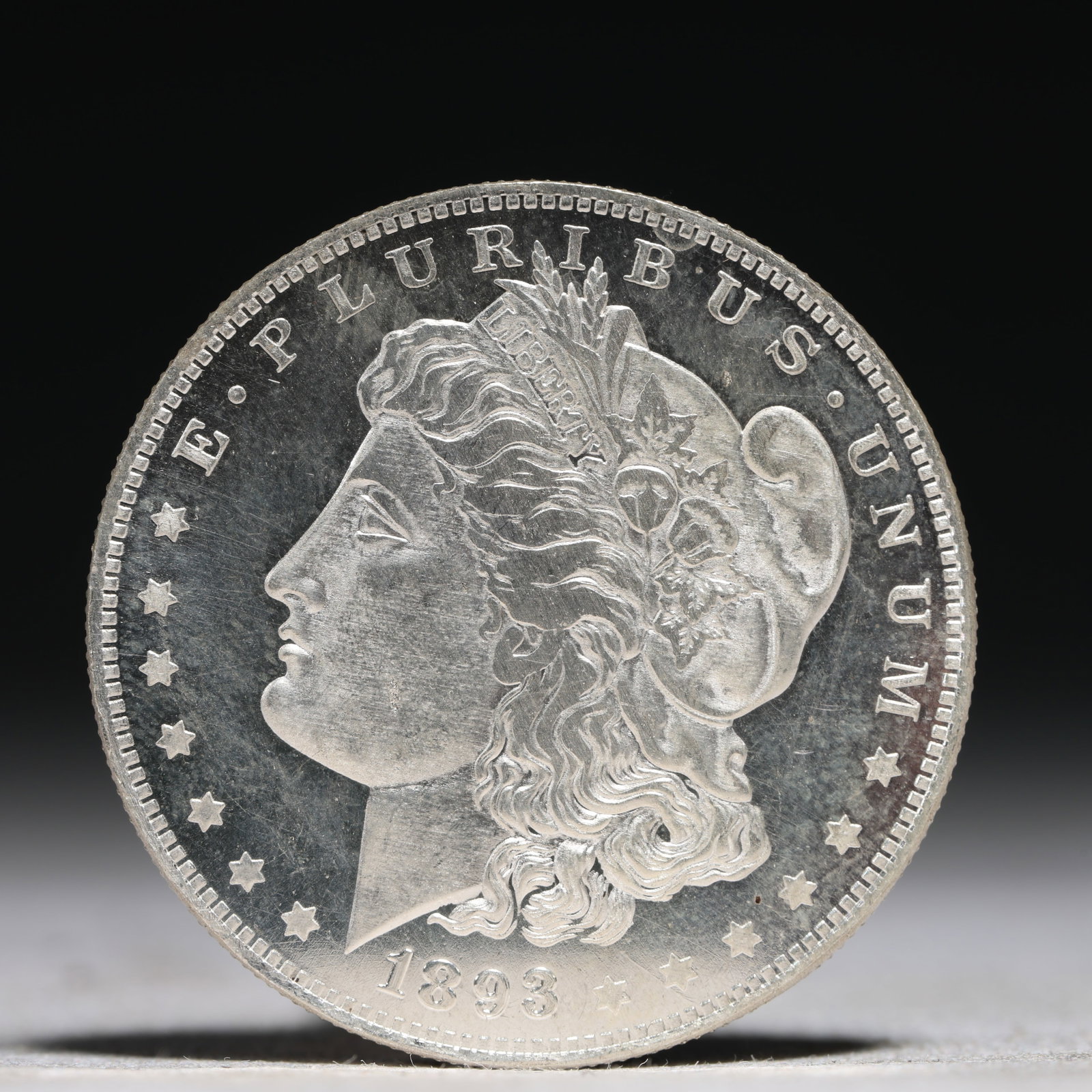USA Morgan Dollar 1893 Coin: Obv: profile bust with date below and E PLURIBUS UNUM legend and stars around. Rev: eagle with In God we trust above within wreath with UNITED STATES OF AMERICA ONE DOLLAR legend. IN GOD WE TRUST / LI