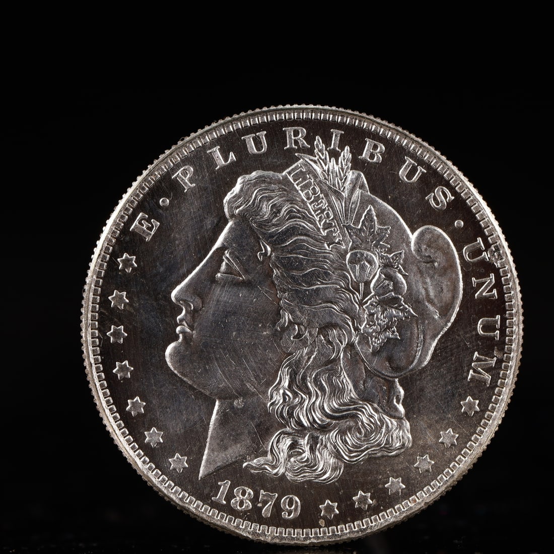 USA Morgan Dollar 1879 Coin: Obv: profile bust with date below and E PLURIBUS UNUM legend and stars around. Rev: eagle with In God we trust above within wreath with UNITED STATES OF AMERICA ONE DOLLAR legend. IN GOD WE TRUST /