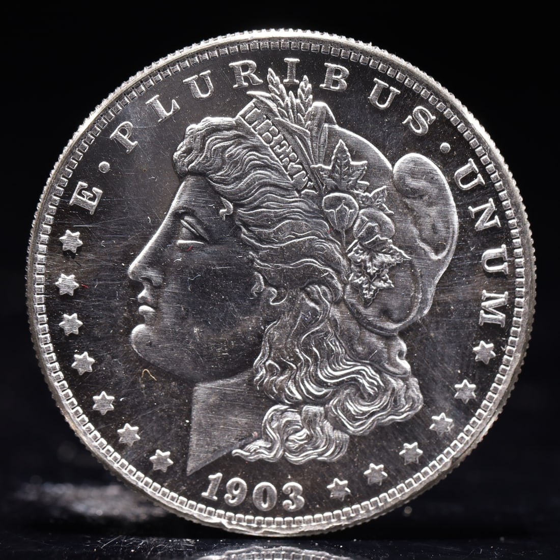 USA Morgan Dollar 1903 Coin: Obv: profile bust with date below and E PLURIBUS UNUM legend and stars around. Rev: eagle with In God we trust above within wreath with UNITED STATES OF AMERICA ONE DOLLAR legend. IN GOD WE TRUST /