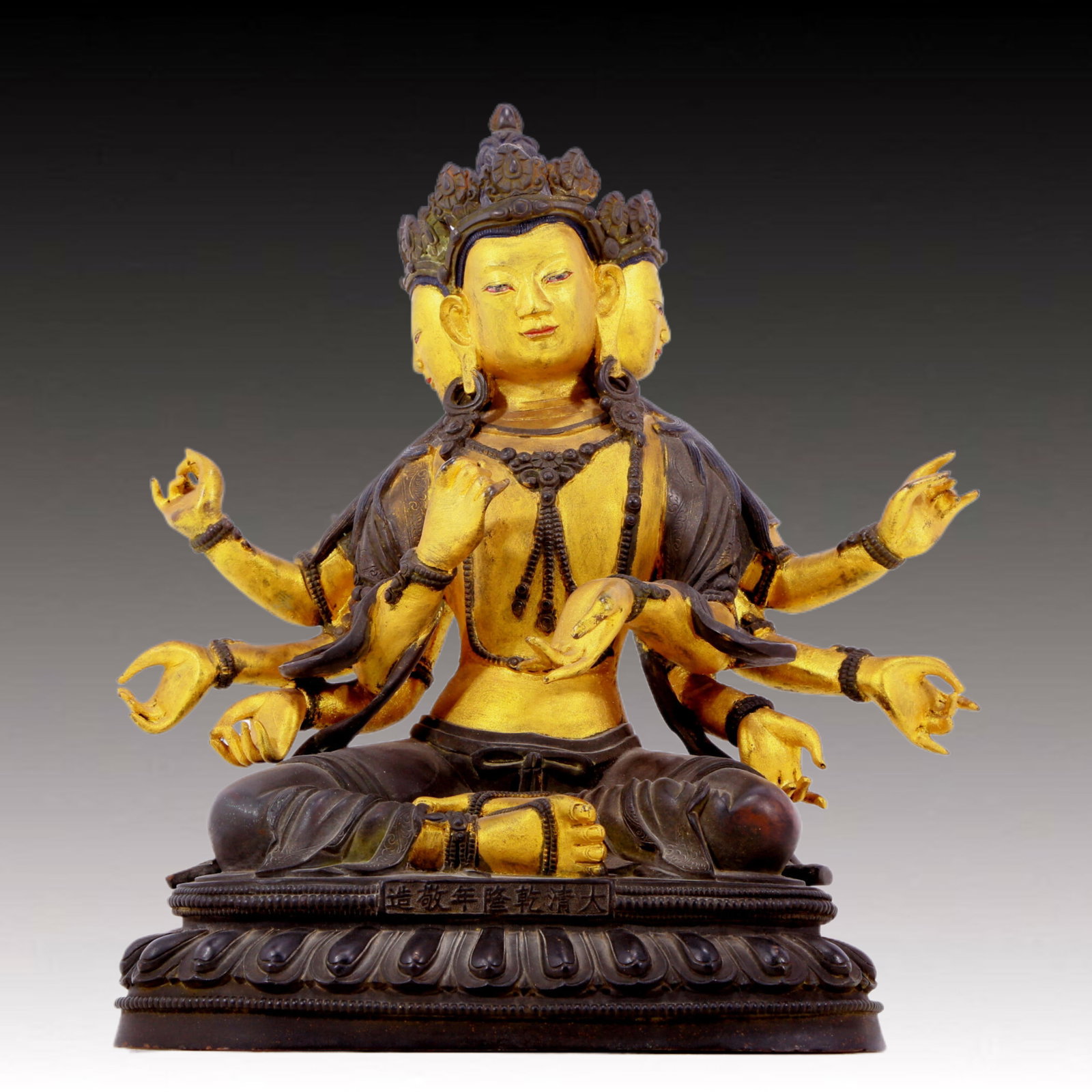 A solemn gilt bronze statue of Bodhisattva: A solemn gilt-bronze Bodhisattva statue, Qianlong seven-character inscription, Qing Dynasty, China. The Bodhisattva's posture is graceful and peaceful. His face is solemn and kind, and his eyes are de