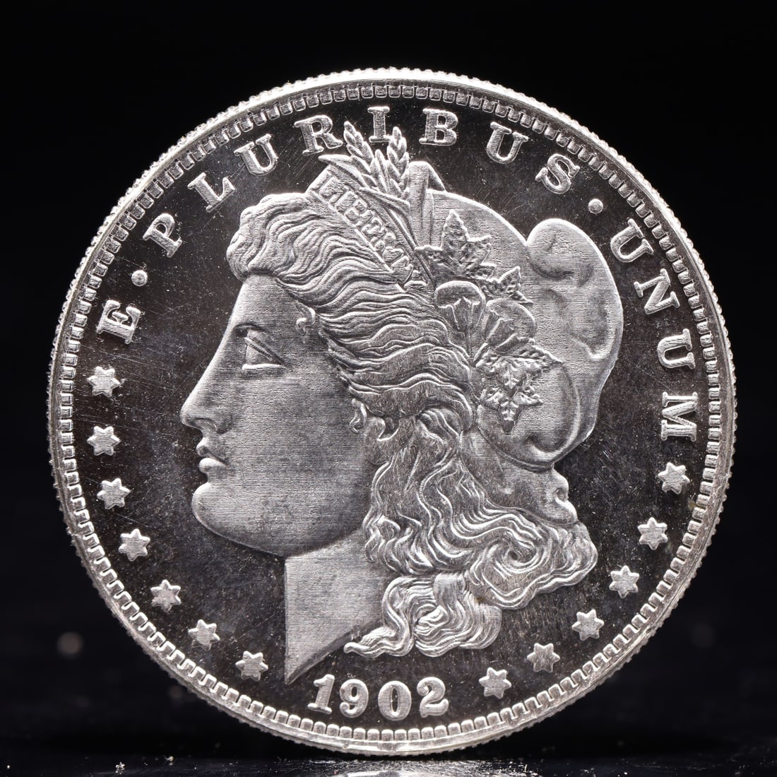 USA Morgan Dollar 1902 Coin: Obv: profile bust with date below and E PLURIBUS UNUM legend and stars around. Rev: eagle with In God we trust above within wreath with UNITED STATES OF AMERICA ONE DOLLAR legend. IN GOD WE TRUST / LI
