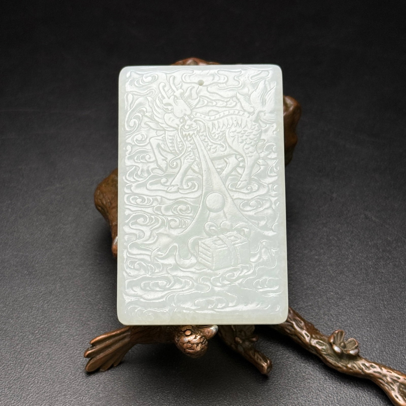 An Exquisite White Jade Auspicious Cloud and Kylin Pattern Pendant: An Exquisite White Jade Auspicious Cloud and Kylin Pattern Pendant,Qing Dynasty,China,Size:1.5inx2.3inx0.2in,Weight:38g 白玉祥云麒麟纹牌,中国