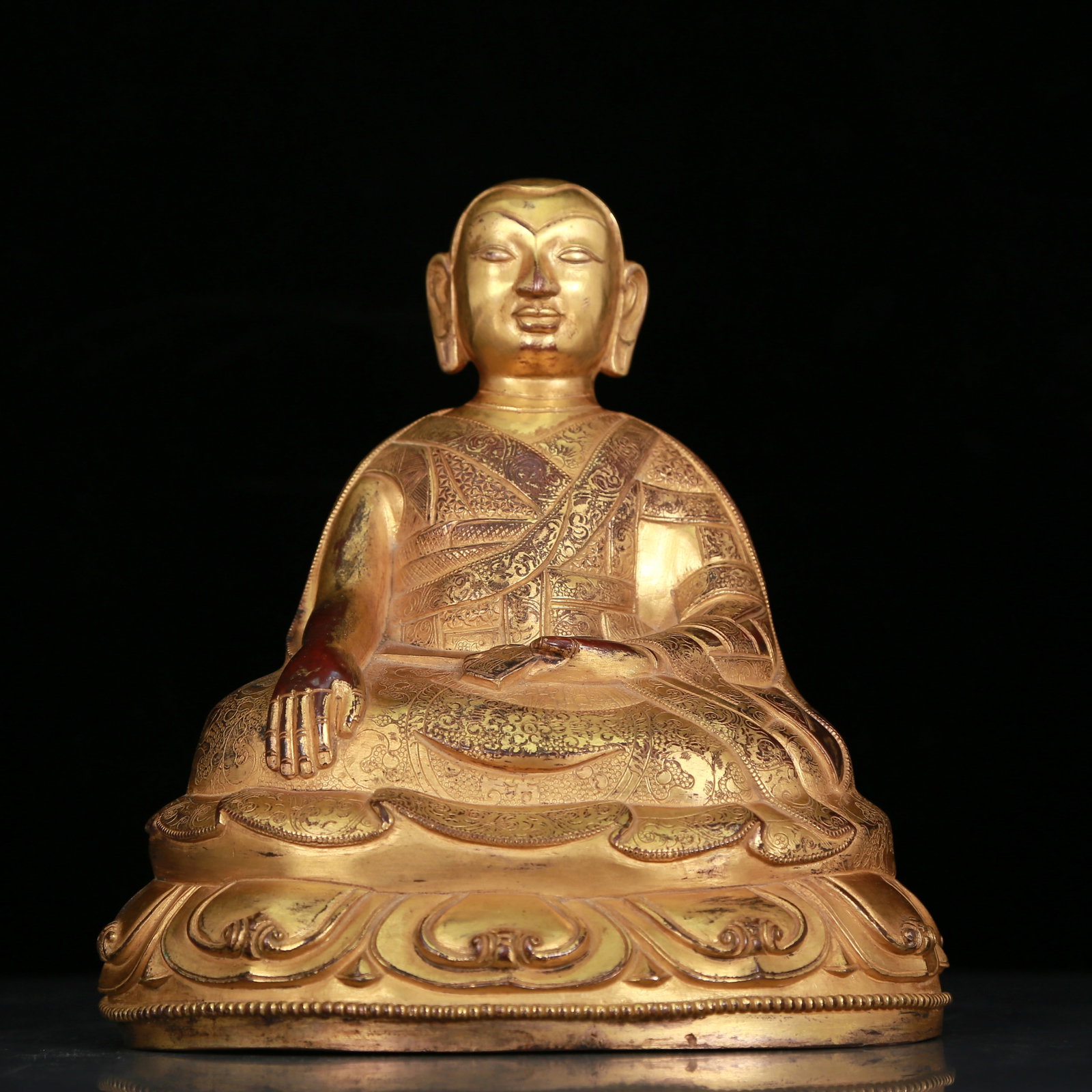 An Elaborate Gilt-Bronze Figure Of Brog.Mi: An Elaborate Gilt-Bronze Figure Of Brog.Mi. Seated with a serene expression, body rendered clad in long, flowing robes, the voluminous drapery elegantly cascading in folds. Chinese Qing Dynasty. Size: