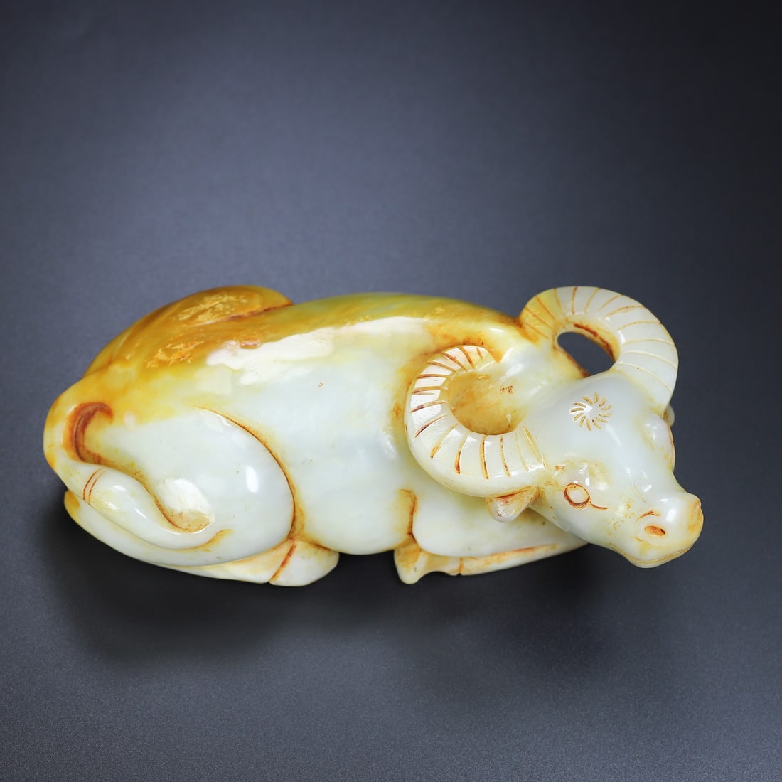An Exquisite White Jade Buffalo Ornament: An Exquisite White Jade Buffalo Ornament Han Dynasty, China Size:6.7inx2.4inx3.4in Weight:1.33kg白玉牛 中国汉代 Size:17cmx6.2cmx8.6cm Weight:1.33kg