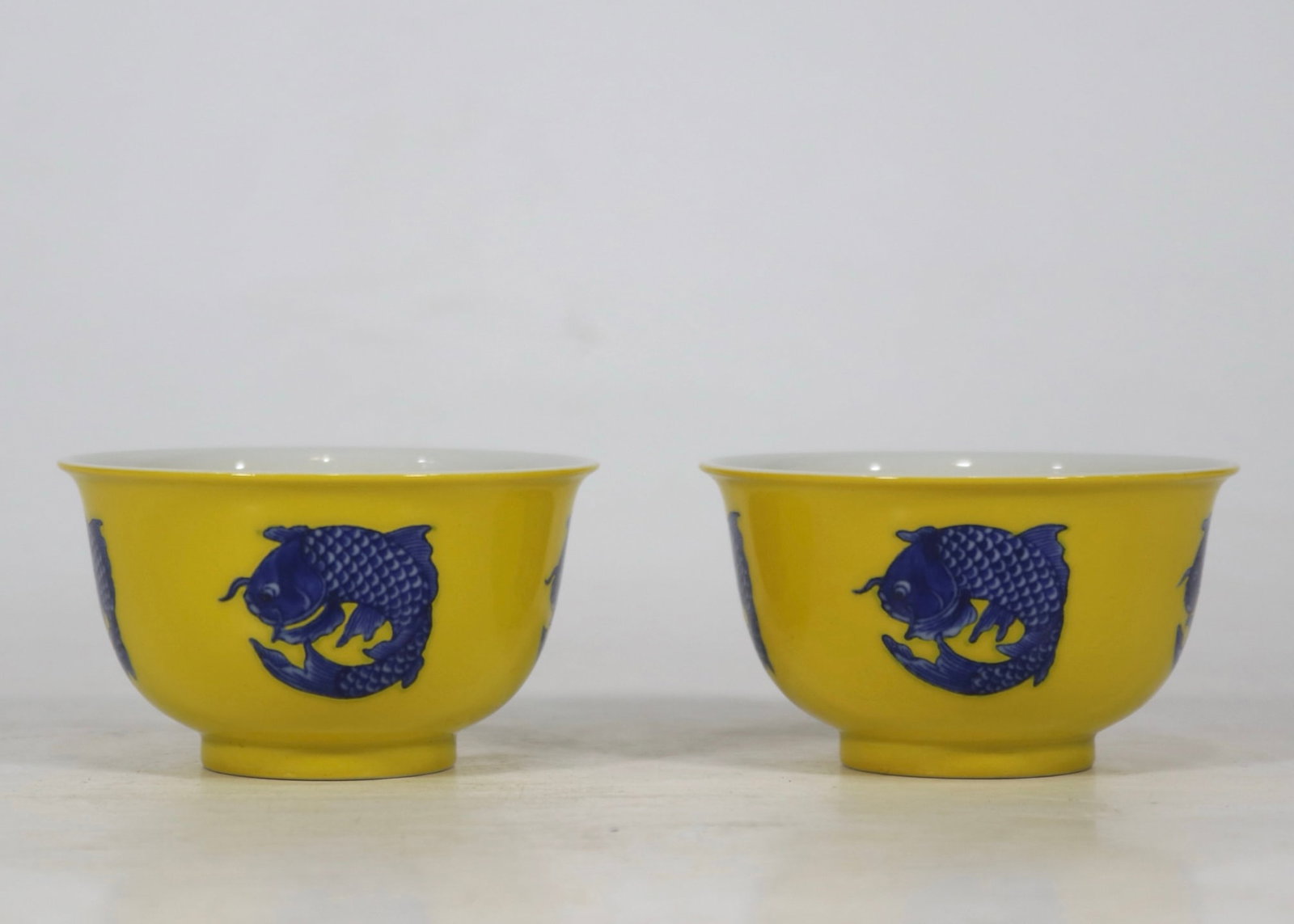 An Exquisite Blue and White Fish Pattern Cup: An Exquisite Blue and White Fish Pattern Cup Qing Dynasty, China Yongzheng Six-character Mark Size:1.8inx3.1in黄底青花团鱼对杯
