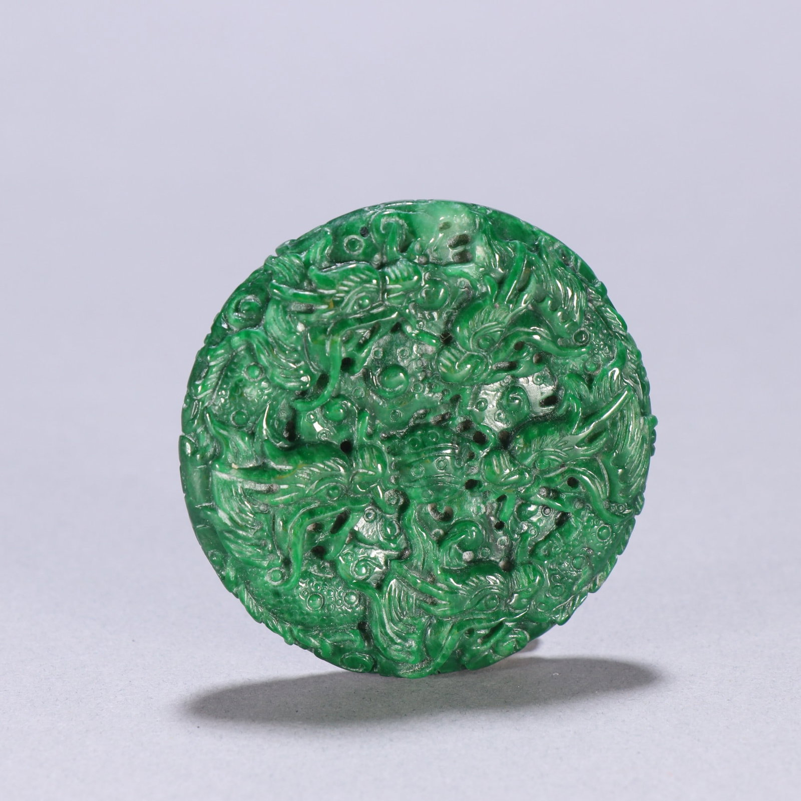 An Exquisite Jadeite Dragon Pattern Brand: An Exquisite Jadeite Dragon Pattern Brand Qing Dynasty, China Size:2.1in Weight:59.4g翡翠九龙戏珠纹圆牌 中国清代 Size:5.4c