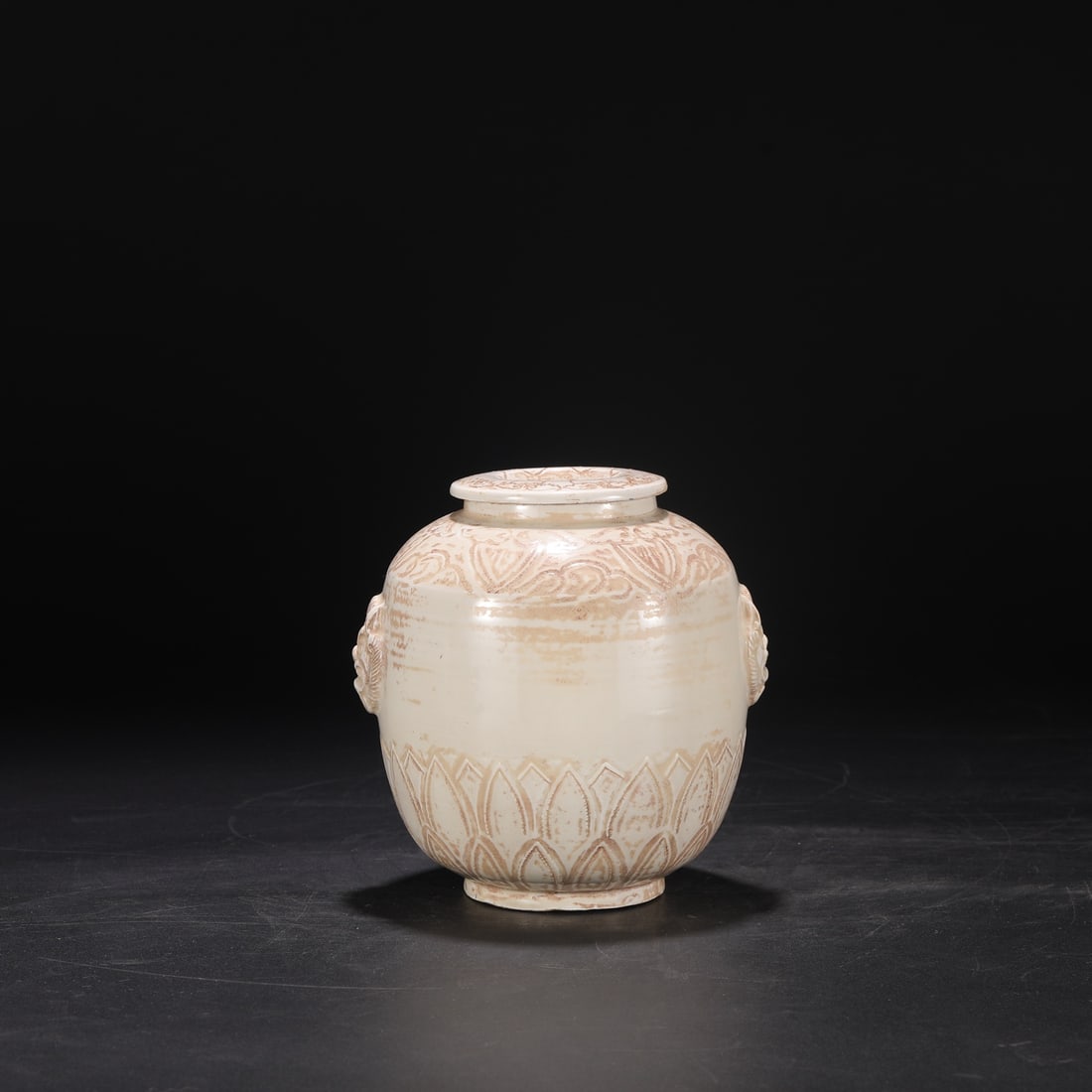An Exquisite Ding yao Double-Ears Jar: An Exquisite Ding yao Double-Ears Jar Song Dynasty, China Size:6.9inx6.3in定窑白釉剔刻莲瓣纹兽耳盖罐