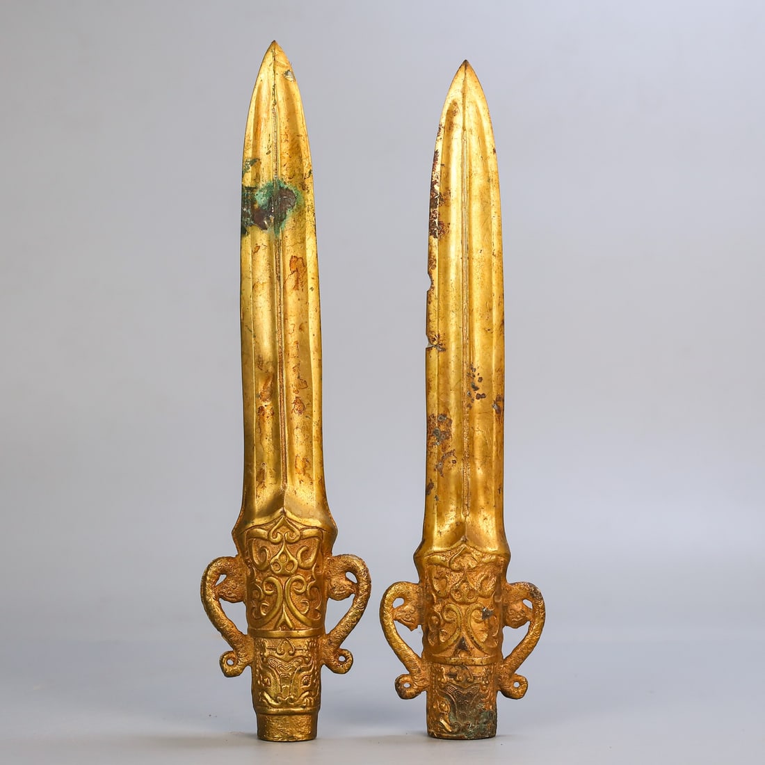 A Pair of Exquisite Gilt Bronze Sword: A Pair of Exquisite Gilt Bronze Sword Han Dynasty, China Size:11.8inx2.8in Weight:1060g铜鎏金兵器一对 中国汉代 Size:30cmx7cm Weight:10
