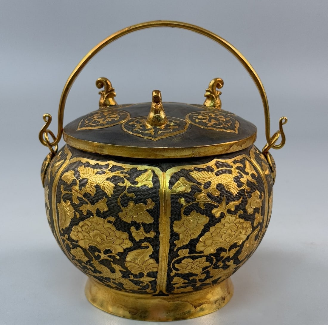 An Exquisite Gilt Bronze Lotus Pattern Ewer: An Exquisite Gilt Bronze Lotus Pattern Ewer Tang Dynasty, China Zhenguan Four-character Mark Size:5.3inx5.9in Weight:1020g铜鎏金錾刻提梁壶