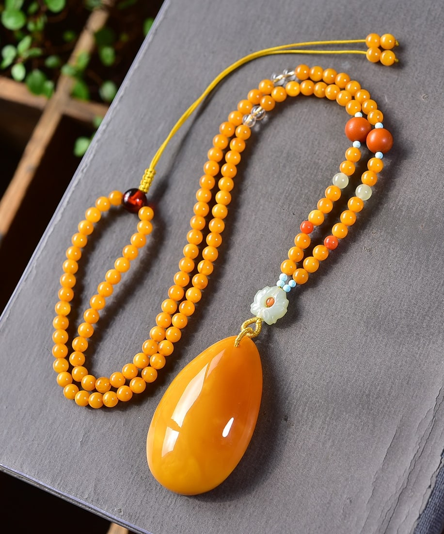 A Exquisite Amber Teardrop Pendant Necklace: Amber Teardrop Pendant Necklace,Qing Dynasty, China,Size:2inx1.2inx0.6in, Weight:23g 花蜡水滴吊坠项链,中国清代
