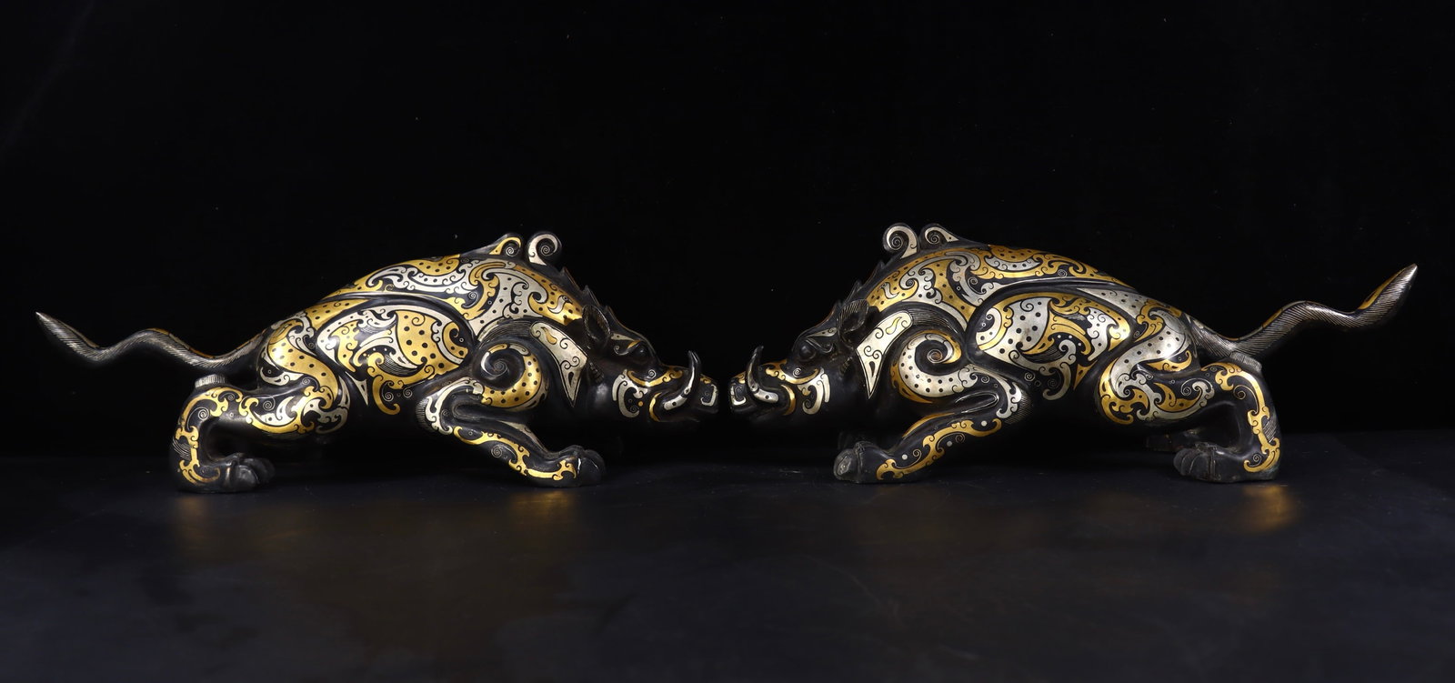 A pair of Exquisite Gold and Silver-Inlaid Bronze Auspicious Beast Ornament: A pair of Exquisite Gold and Silver-Inlaid Bronze Auspicious Beast Ornament,Han Dynasty, China,Size:5.5inx14.6inx4.9in,Weight:3790g 一对青铜错金银瑞