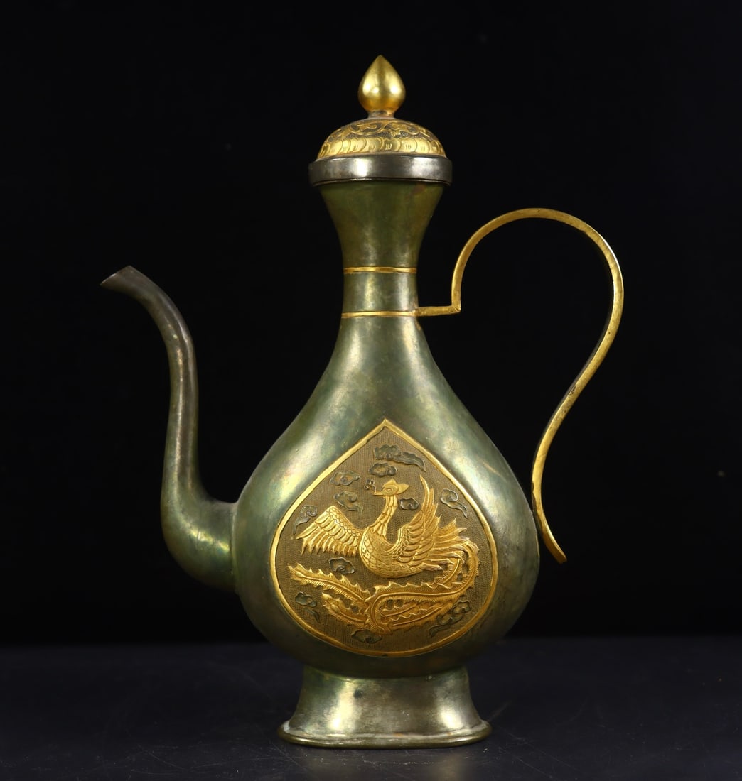 A Exquisite Gilt Bronze Phoenix Pattern Ewer: A Exquisite Gilt Bronze Phoenix Pattern Ewer,Tang Dynasty, China,Zhenguan Four-character Mark,Size:10.4inx7.9inx3in,Weight:674g 铜鎏金凤纹壶,中国唐