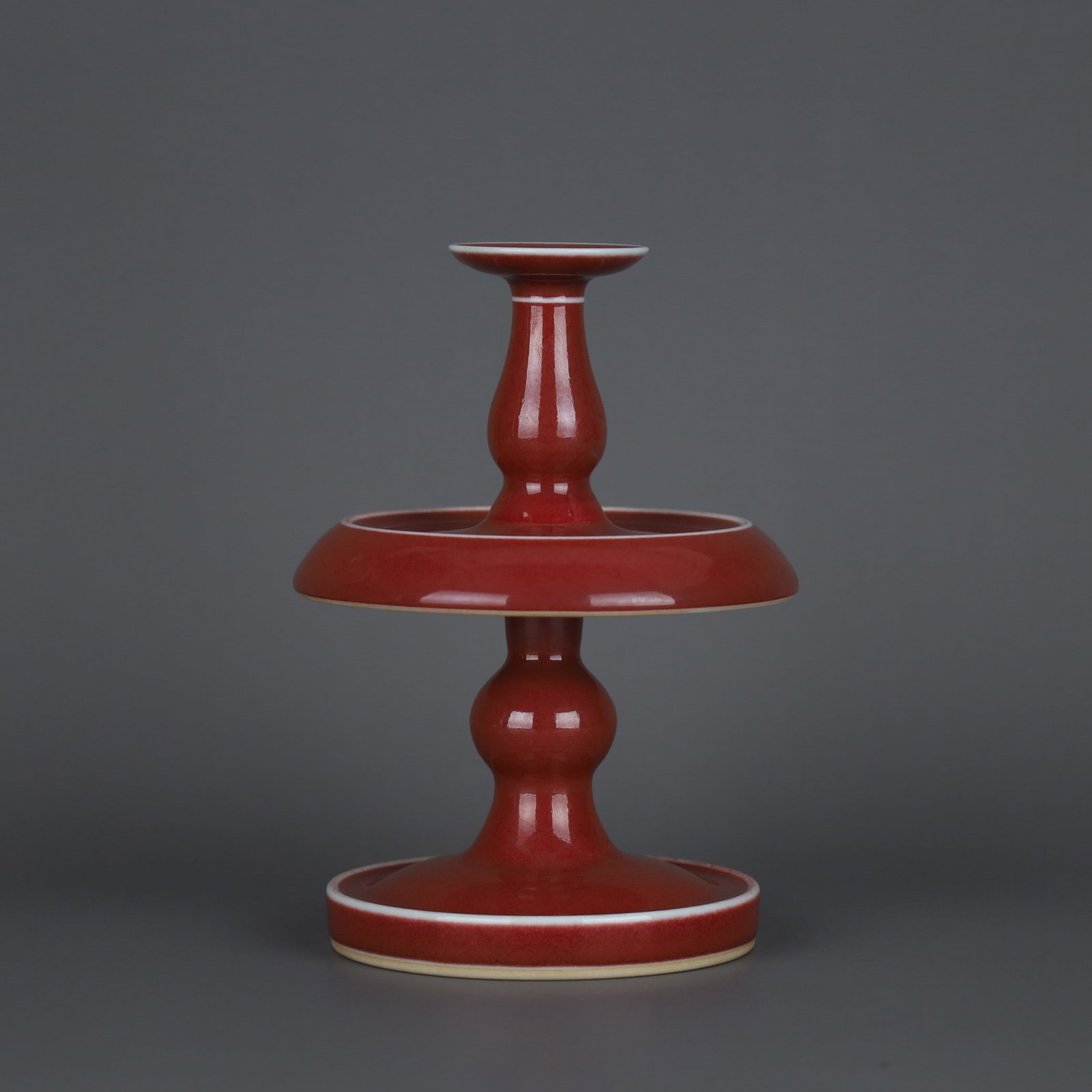A Exquisite Ji Red Glaze Candlestick: A Exquisite Ji Red Glaze Candlestick,Qing Dynasty, China,Qianlong Six-character Mark,Size:6.1inx4.3in 霁红釉烛台,中国清代,乾隆六