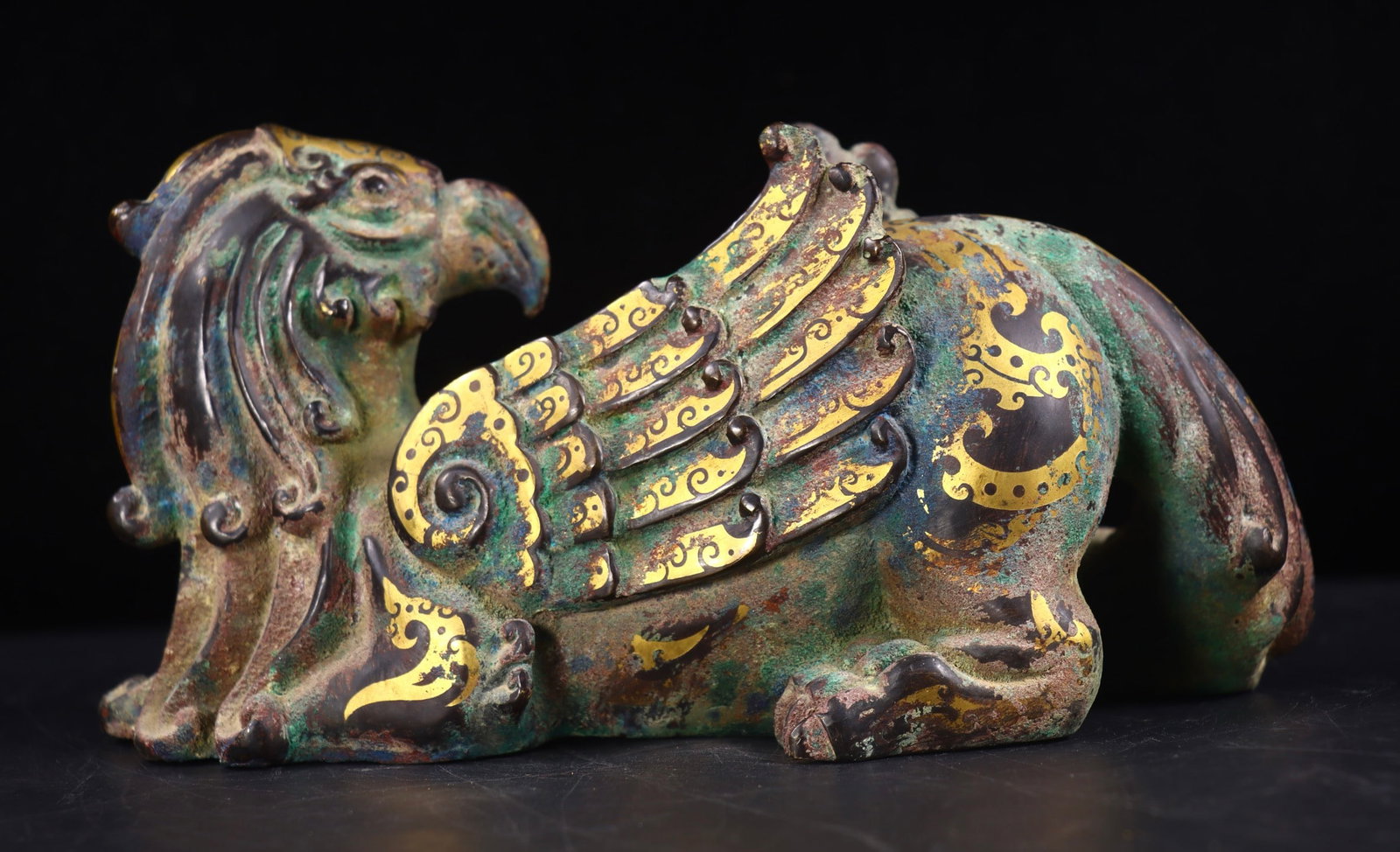 A Exquisite Gold and Silver-Inlaid Bronze Auspicious Beast Ornament: A Exquisite Gold and Silver-Inlaid Bronze Auspicious Beast Ornament,Han Dynasty, China,Size:4.7inx9.1inx4.3in,Weight:1867g 青铜错金银瑞兽摆件,