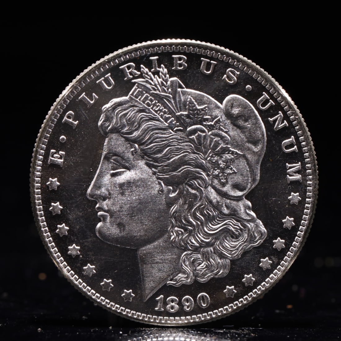USA Morgan Dollar 1890 Coin: Obv: profile bust with date below and E PLURIBUS UNUM legend and stars around. Rev: eagle with In God we trust above within wreath with UNITED STATES OF AMERICA ONE DOLLAR legend. IN GOD WE TRUST / LI