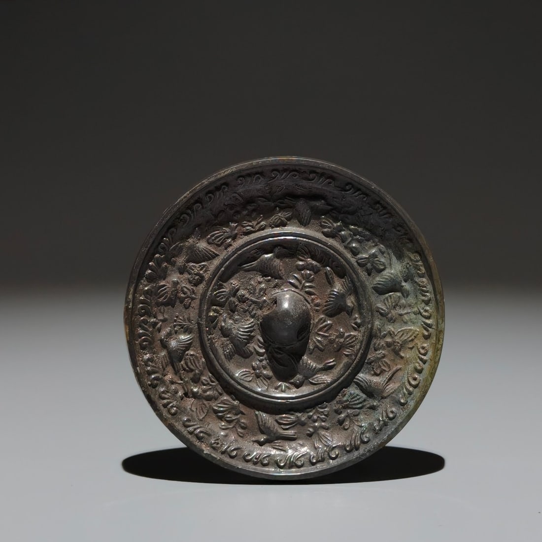 An Exquisite Bronze Flower and Bird Pattern Mirror: An Exquisite Bronze Flower and Bird Pattern Mirror,Tang Dynasty,China,Size:3.5in 铜花鸟纹镜子,中国唐代