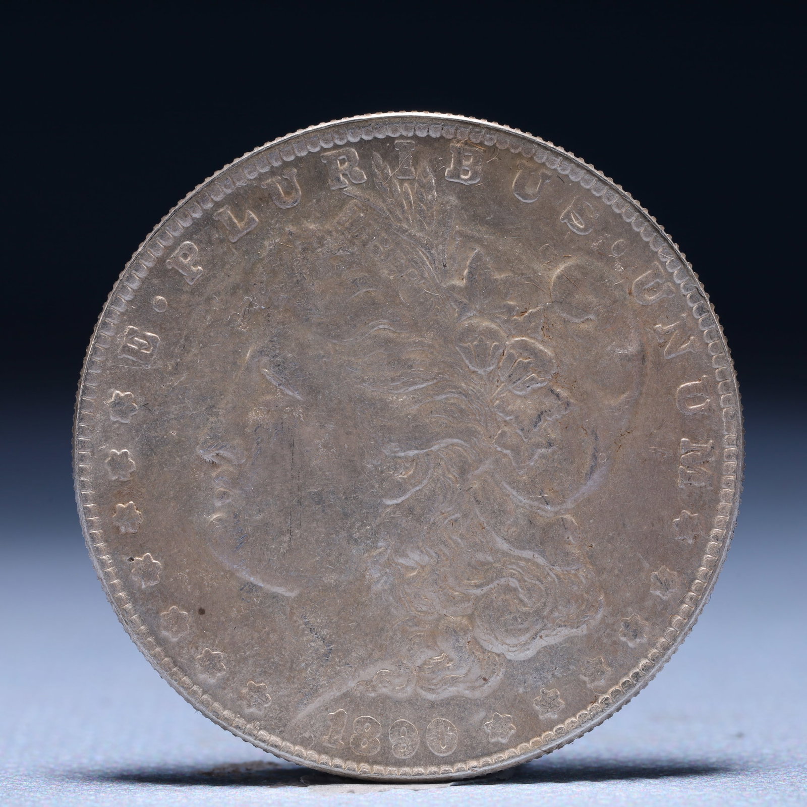 USA Morgan Dollar 1890 Coin: Obv: profile bust with date below and E PLURIBUS UNUM legend and stars around. Rev: eagle with In God we trust above within wreath with UNITED STATES OF AMERICA ONE DOLLAR legend. IN GOD WE TRUST / LI