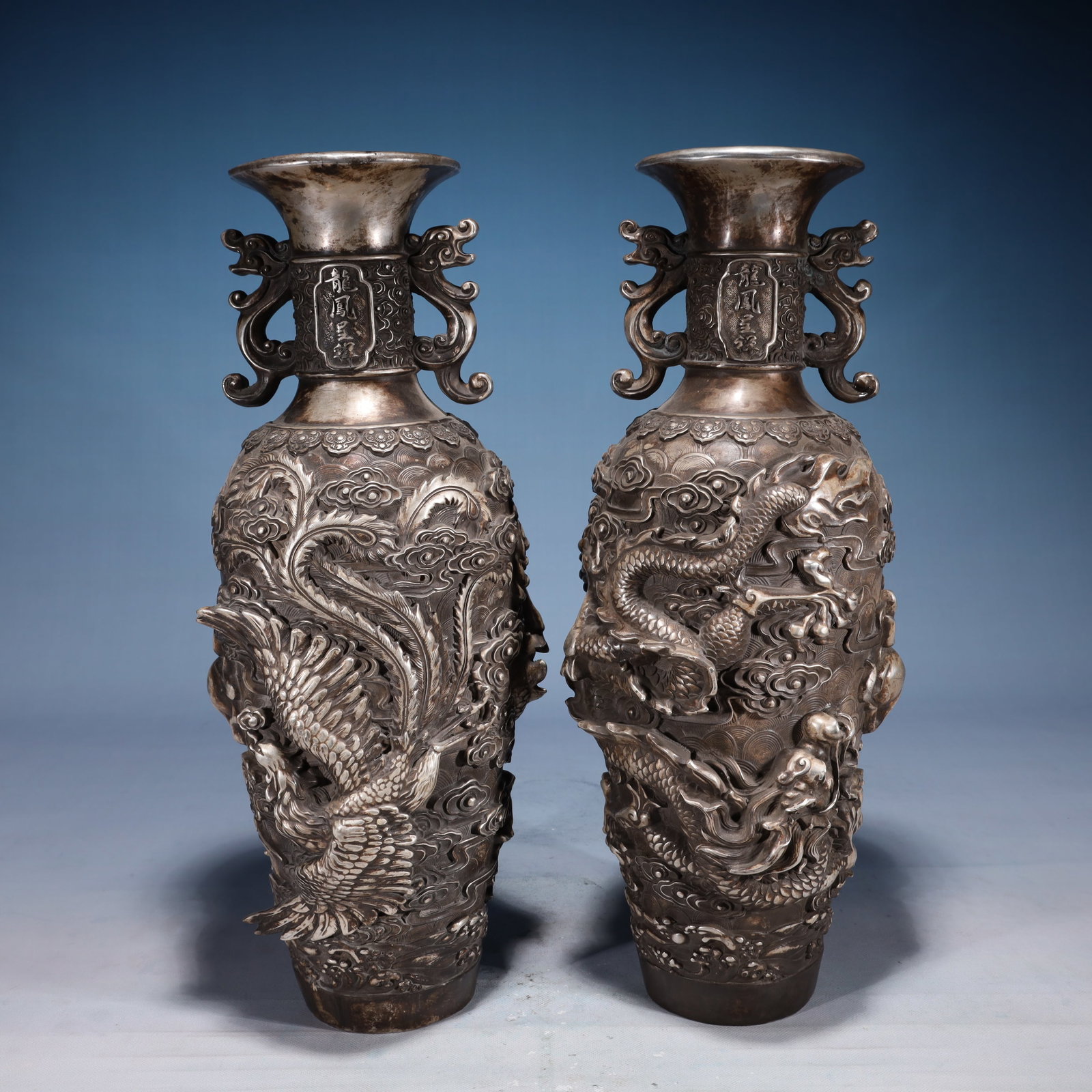 A Pair of Exquisite Silver-plated Bronze Dragon and Phoenix Pattern Double-Ears Vases: A Pair of Exquisite Silver-plated Bronze Dragon and Phoenix Pattern Double-Ears Vases,Qing Dynasty,China,Qianlong Four-character Mark,Size:6.3inx18.9in,Weight:8000g 一对铜镀