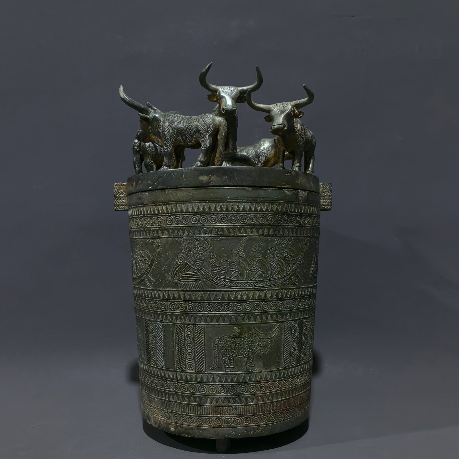 An Archaic Bronze Figure Pattern Double-Ears and Tripod Barrel,With Buffalo Pattern Cover: An Archaic Bronze Figure Pattern Double-Ears and Tripod Barrel,With Buffalo Pattern Cover,the Warring States period in China,Size:10inx6.5inx5.7in,Weight:2kg