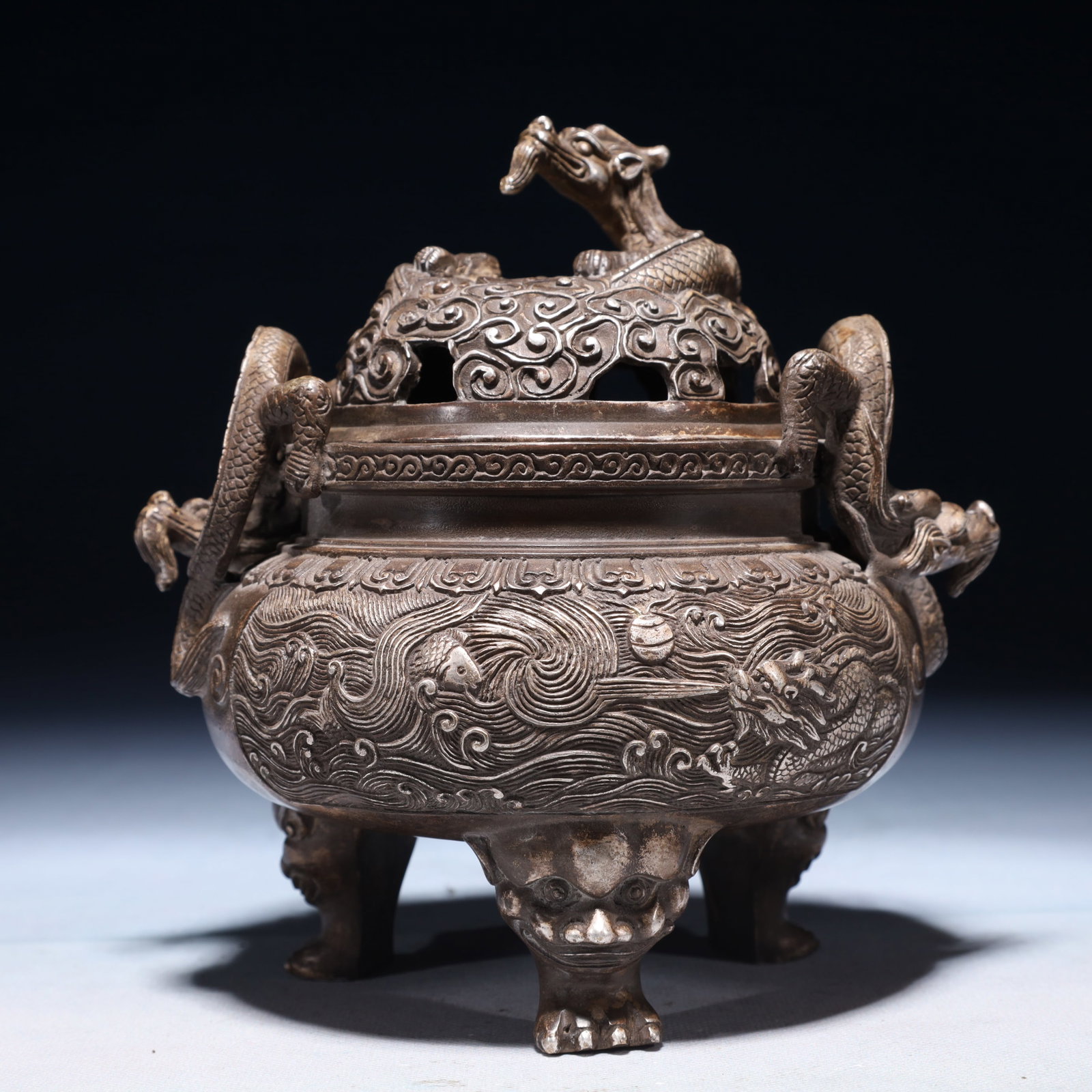 An Exquisite Silver-plated Bronze Seawater and Dragon Pattern Double-Ears and Tripod Censer: An Exquisite Silver-plated Bronze Seawater and Dragon Pattern Double-Ears and Tripod Censer,Qing Dynasty,China,Qianlong Four-character Mark,Size:6.7inx7.1in,Weight:1500g 铜镀银૲