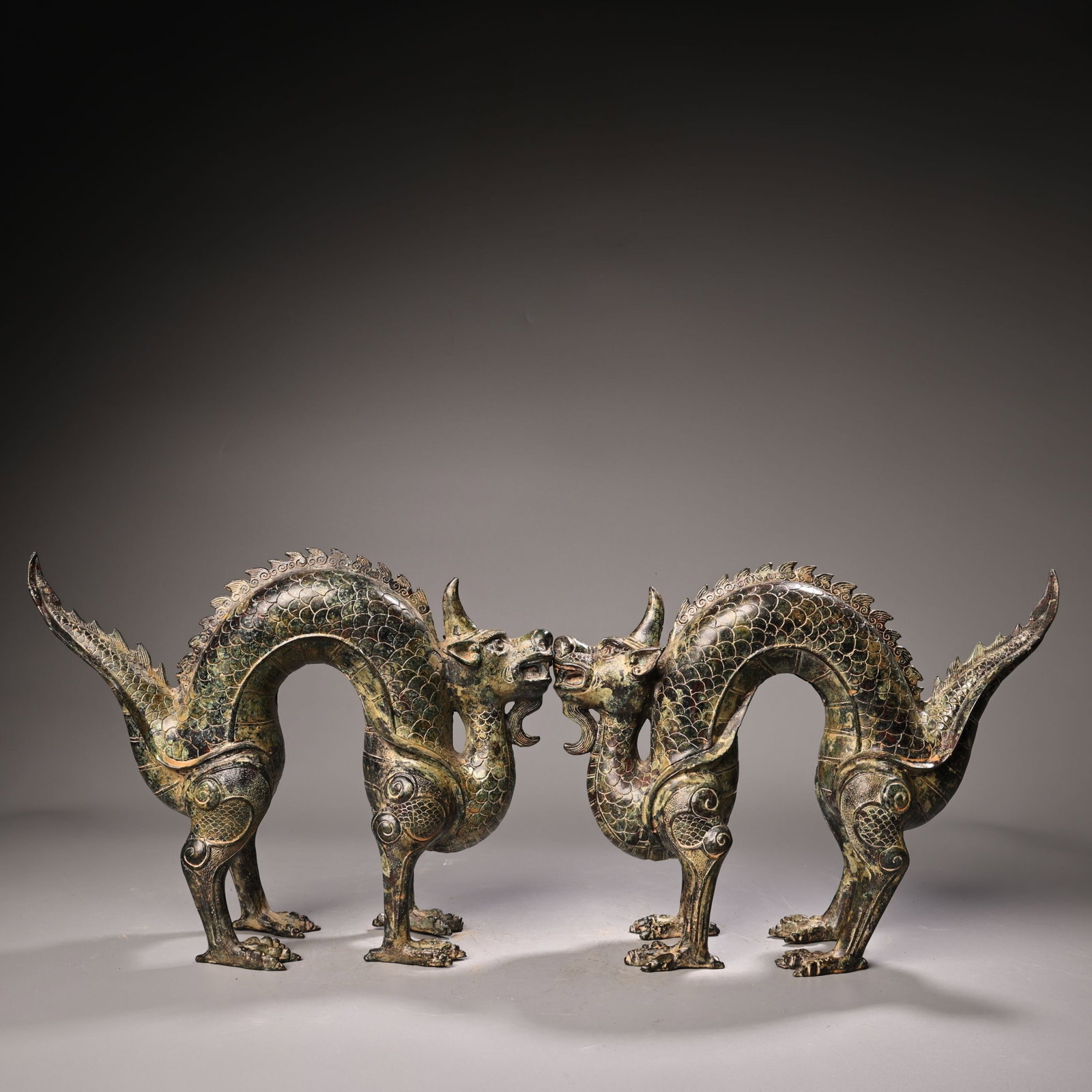 A Pair of Archaic Bronze Dragon Ornaments: A Pair of Archaic Bronze Dragon Ornaments,Ancient Time,China,Size:9.8inx12.6in,Weight:3000g 一对青铜龙摆件,中国远古时期