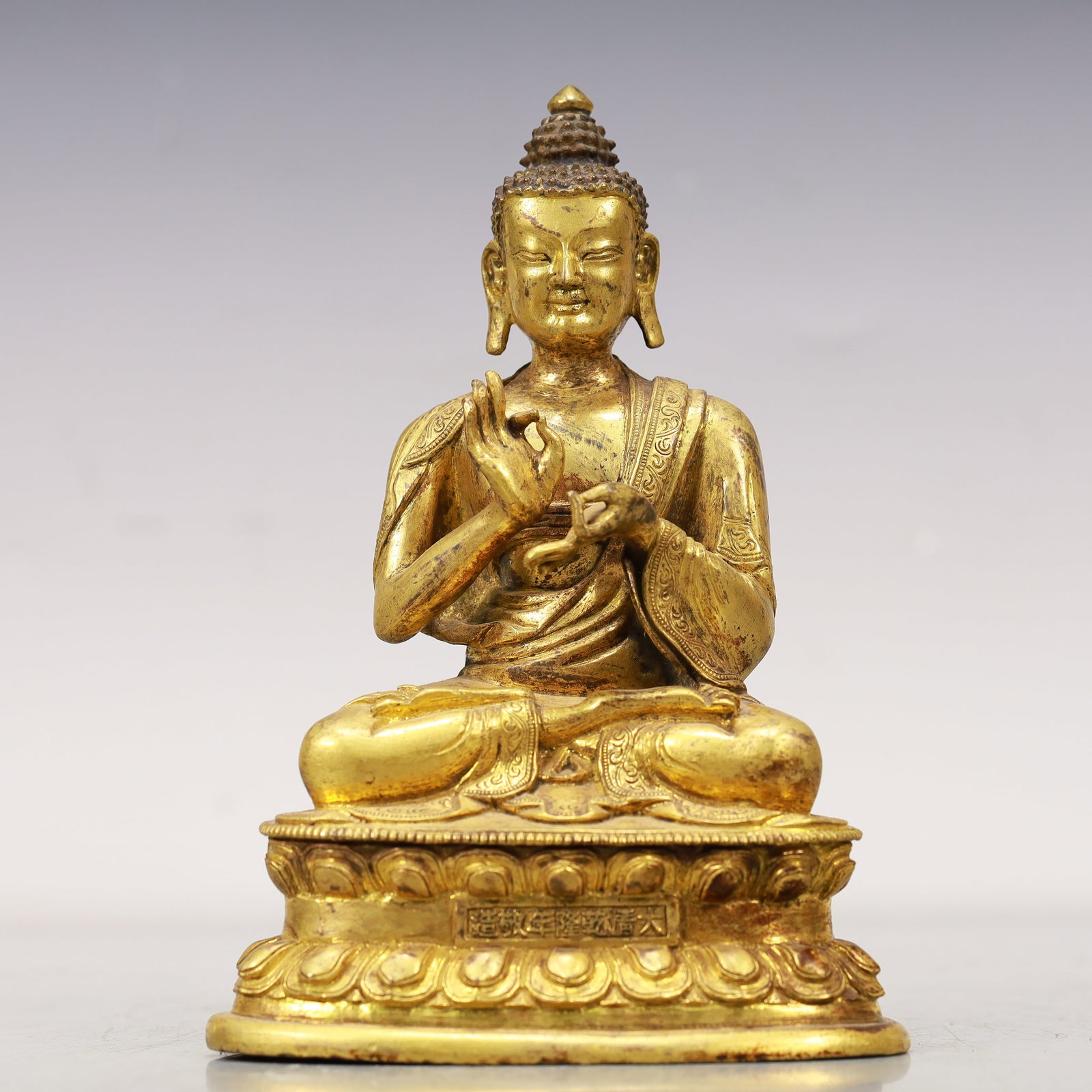 An Excellent Gilt-Bronze Figure Of Buddha Shakyamuni: An Excellent Gilt-Bronze Figure Of Buddha Shakyamuni. Superbly and sensitively sculpted in the form of a seated Buddha Shakyamuni,with well-defined arched eyebrows juxtaposed with the prominent nose a