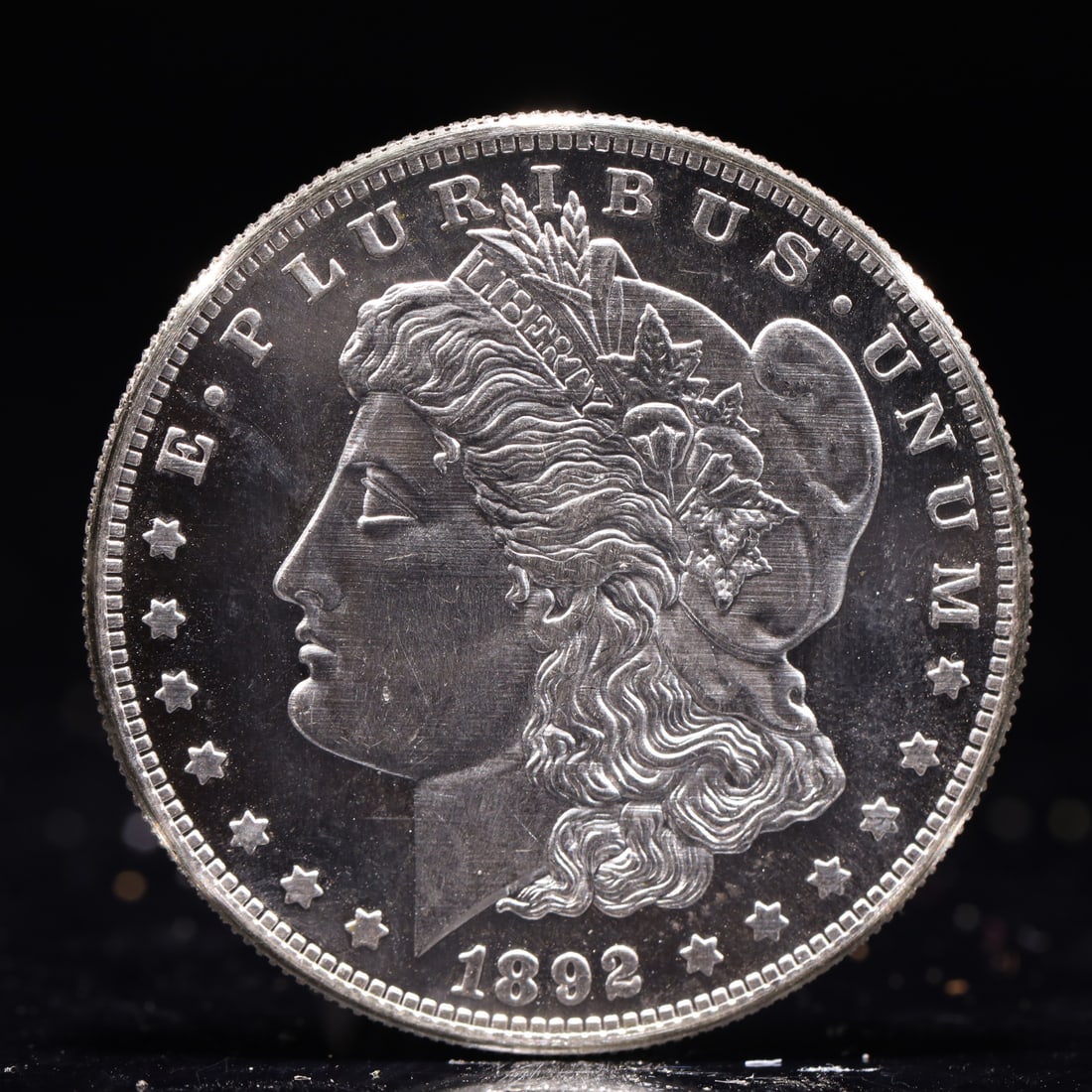 USA Morgan Dollar 1892 Coin: Obv: profile bust with date below and E PLURIBUS UNUM legend and stars around. Rev: eagle with In God we trust above within wreath with UNITED STATES OF AMERICA ONE DOLLAR legend. IN GOD WE TRUST / LI