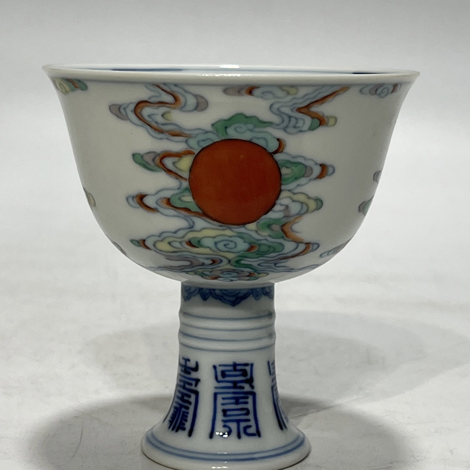 An Exquisite Doucai Auspicious Cloud and Sun Pattern Stem Cup: An Exquisite Doucai Auspicious Cloud and Sun Pattern Stem Cup,Qing Dynasty,China,Yongzheng Six-character Mark,Size:3.4in 斗彩祥云太阳纹高足杯