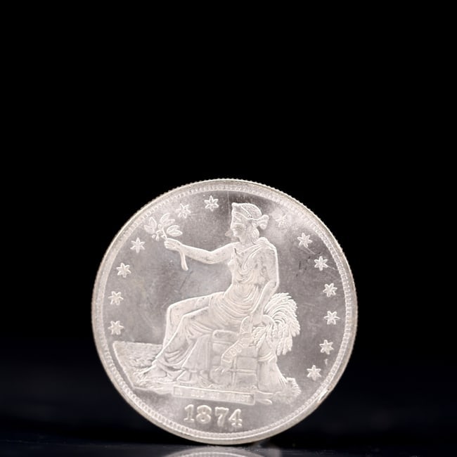 American coin. Obverse: Liberty seated on a pedestal facing the sea to the left holding olive: American coin. Obverse: Liberty seated on a pedestal facing the sea to the left holding olive branches surrounded by 13 stars. IN GOD WE TRUST / LIBERTY / 1874. Reverse: An eagle holding branches with
