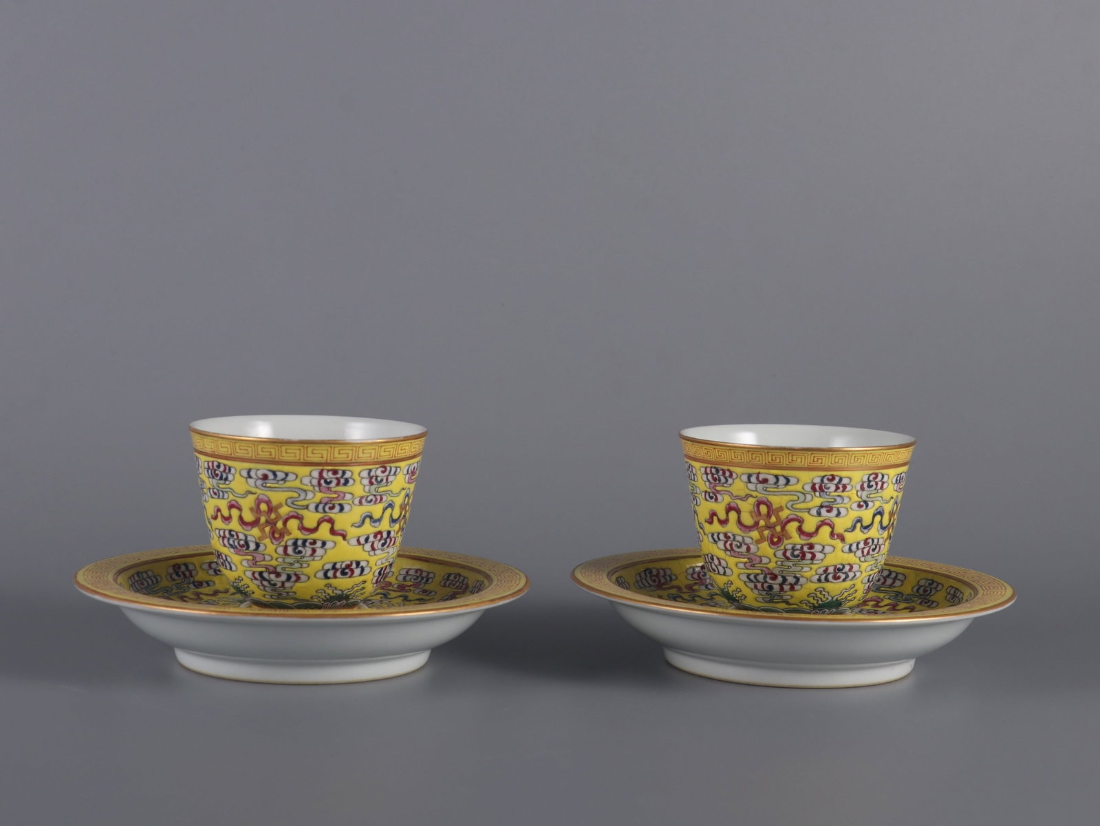 A Pair of Exquisite Yellow Ground Famille-Rose Auspicious Cloud Pattern Cups,with Plate: A Pair of Exquisite Yellow Ground Famille-Rose Auspicious Cloud Pattern Cups,with Plate,Qing Dynasty,China,Qianlong Six-character Mark,Size:2.8inx2.8in 一对黄地粉彩