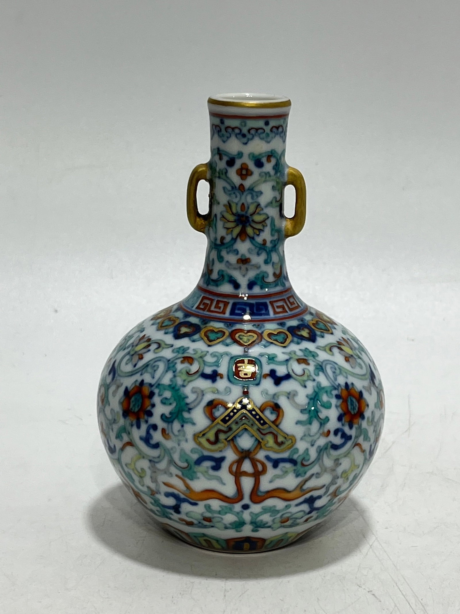 An Exquisite Doucai Painted Gold Lotus Pattern Double-Ears Vase: An Exquisite Doucai Painted Gold Lotus Pattern Double-Ears Vase,Qing Dynasty,China,Qianlong Six-character Mark,Size:5in 斗彩描金缠枝莲纹双耳