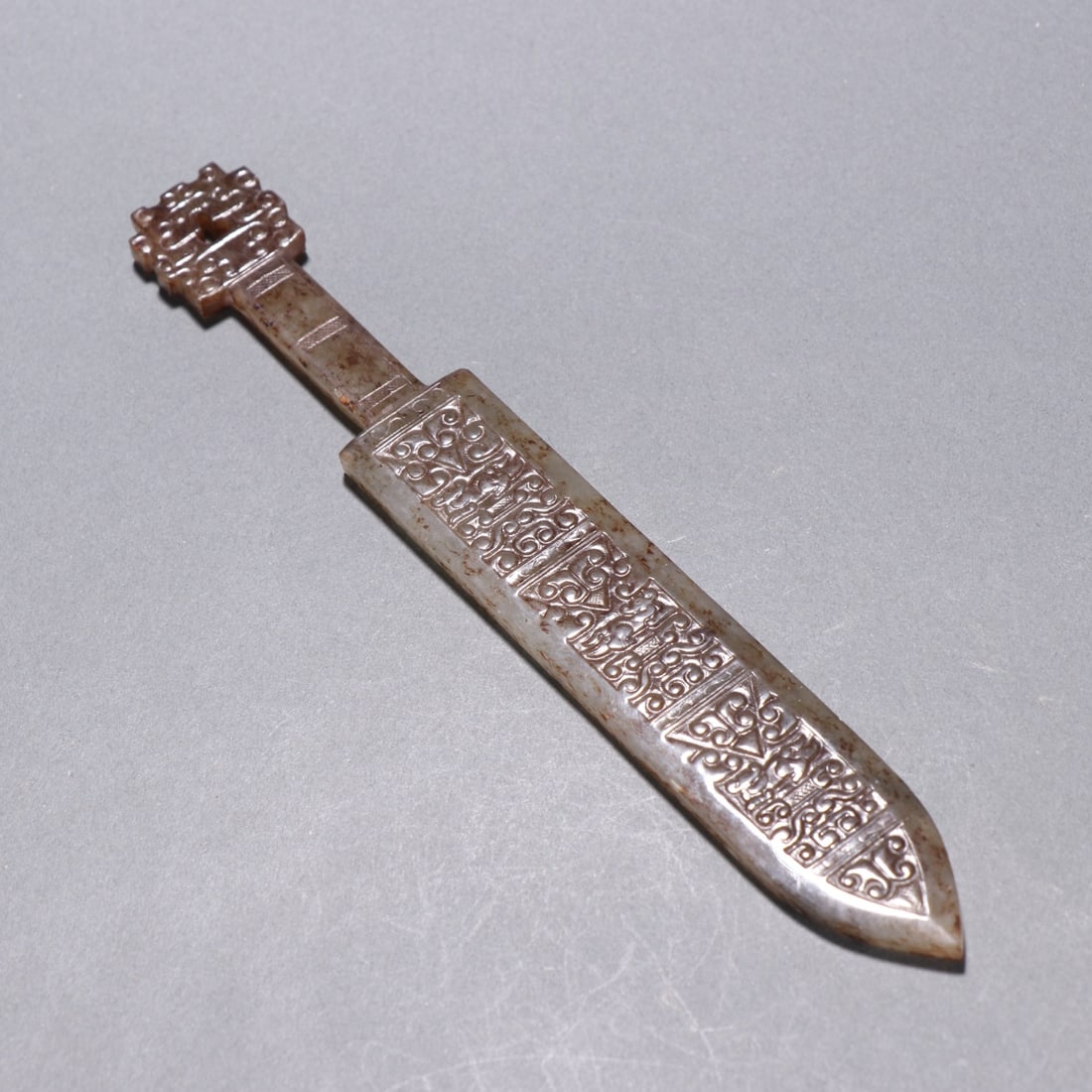 An Exquisite Gaogu Jade Ruyi Pattern Sword: An Exquisite Gaogu Jade Ruyi Pattern Sword,Han Dynasty, China,Size:5.9inx0.8in ,Weight:27g 高古玉如意纹剑,中国汉代