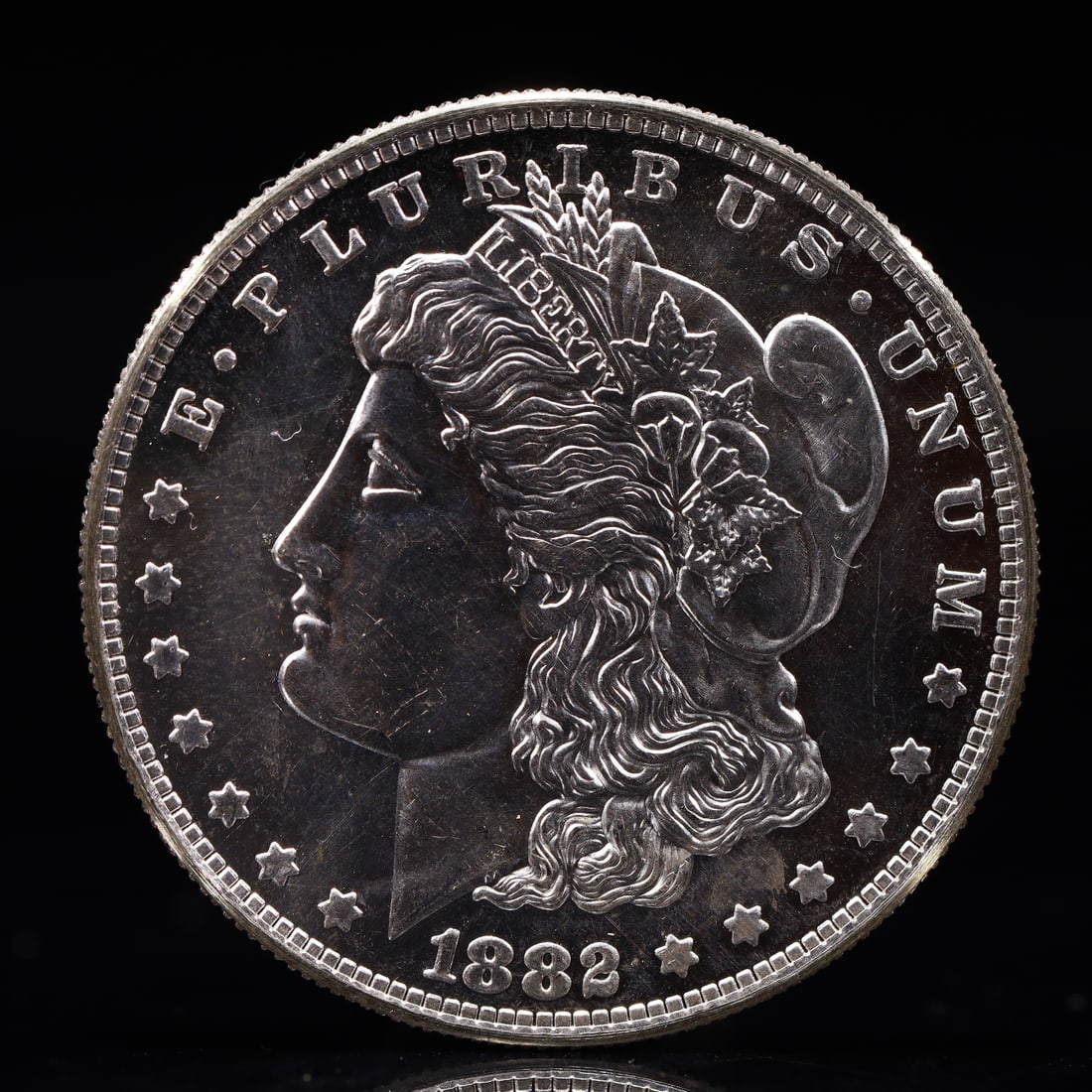 USA Morgan Dollar 1882 Coin: Obv: profile bust with date below and E PLURIBUS UNUM legend and stars around. Rev: eagle with In God we trust above within wreath with UNITED STATES OF AMERICA ONE DOLLAR legend. IN GOD WE TRUST /