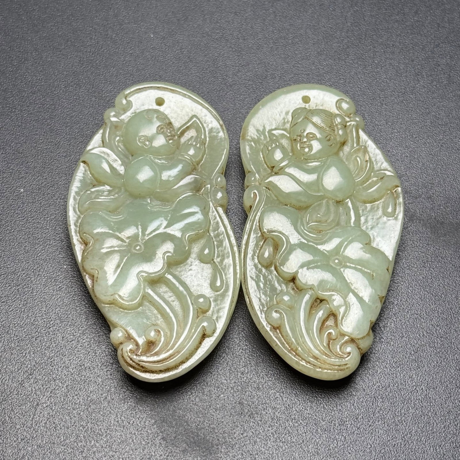 A Pair of Exquisite White Jade Lotus and Figure Pattern Pendants: A Pair of Exquisite White Jade Lotus and Figure Pattern Pendants,Qing Dynasty,China,Size:1.3inx2.7inx0.4in,Total Weight:73g 一对白玉莲花人物纹