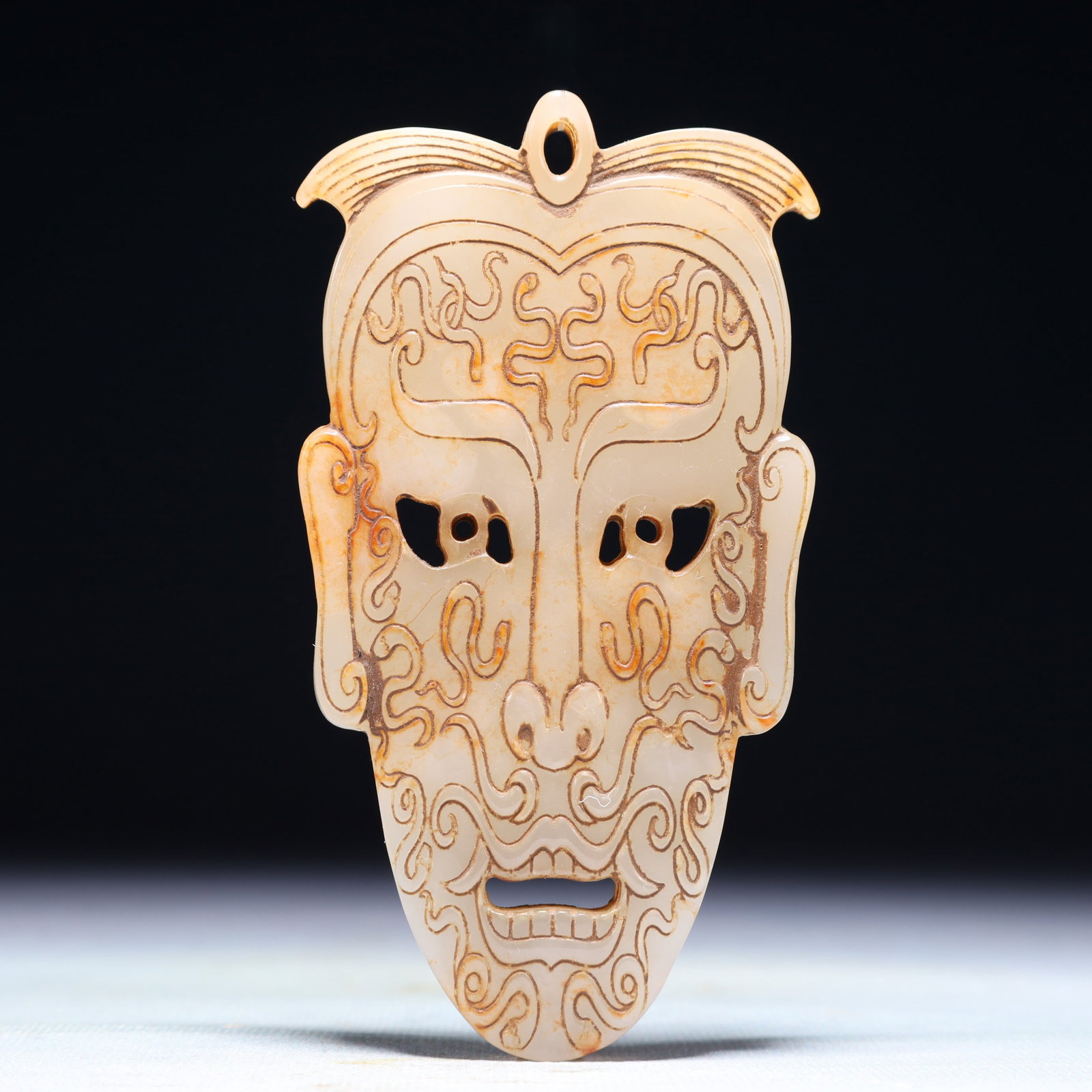 An Exquisite White Jade Figure-Face Pattern Pendant: An Exquisite White Jade Figure-Face Pattern Pendant,Qing Dynasty,China,Size:2.4inx4.7in,Weight:138.6g 白玉人面纹佩,中国清代