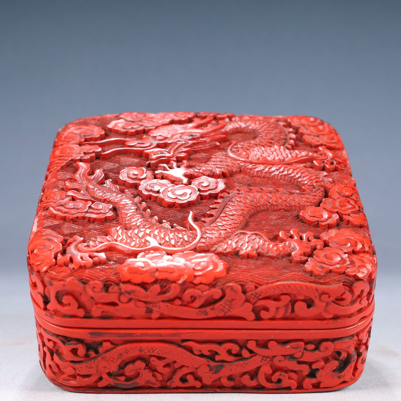 An Exquisite Carved Red Lacquer Auspicious Cloud and Dragon Pattern Cover Box: An Exquisite Carved Red Lacquer Auspicious Cloud and Dragon Pattern Cover Box,Qing Dynasty, China,Size:5.3inx2.2in,Weight:350g 剔红漆祥云龙纹盖盒,