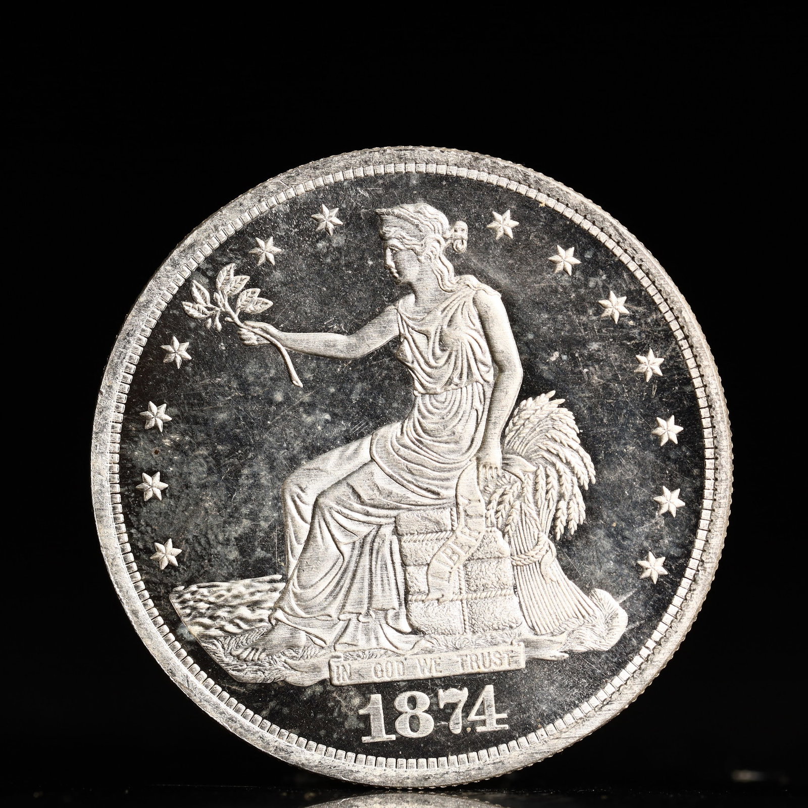 USA Trade Dollar 1874 Coin: American coin. Obverse: Liberty seated on a pedestal facing the sea to the left holding olive branches surrounded by 13 stars. IN GOD WE TRUST / LIBERTY / 1874. Reverse: An eagle holding branches with